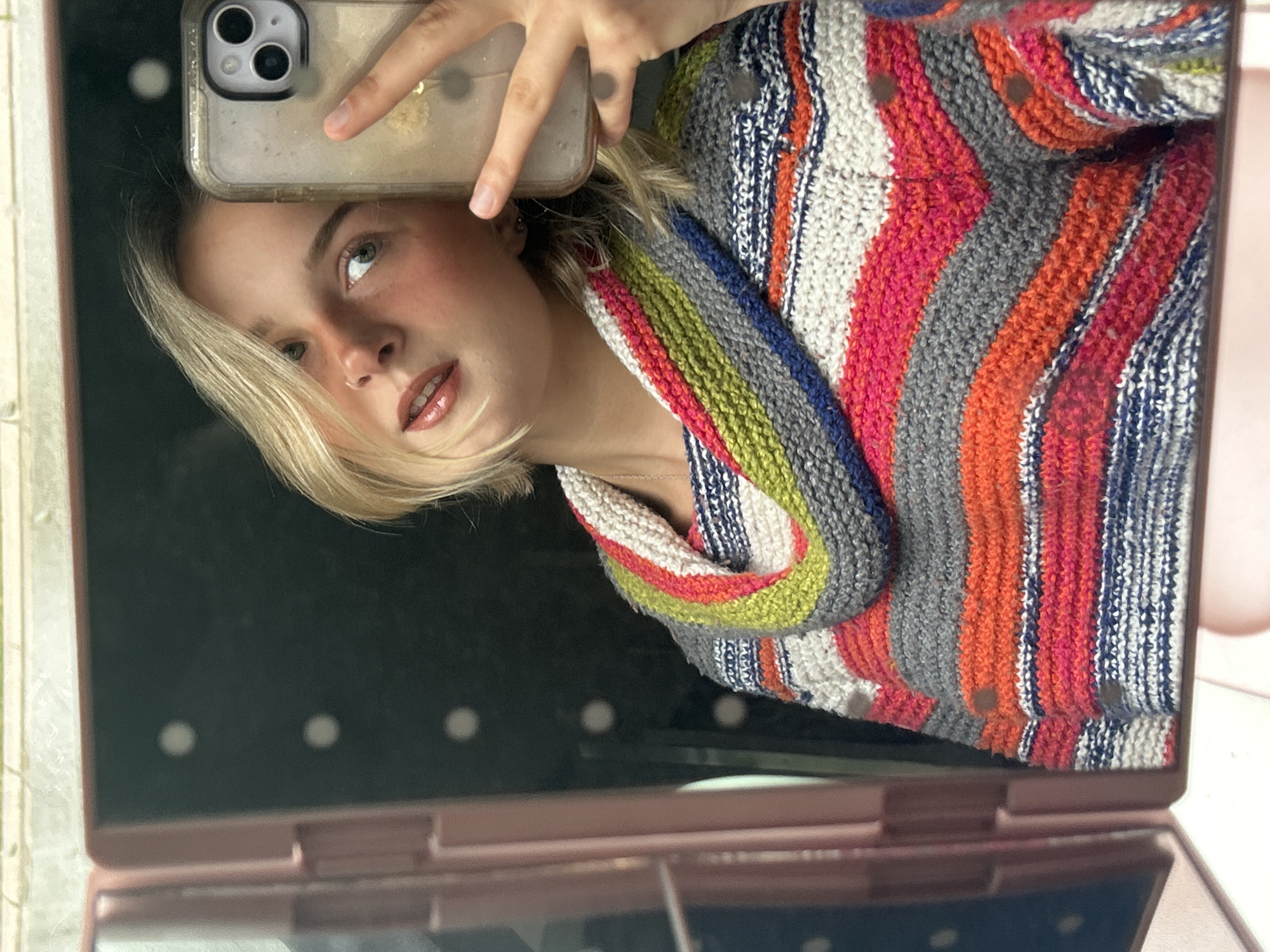 Woman takes selfies with makeup mirror in Whistler
