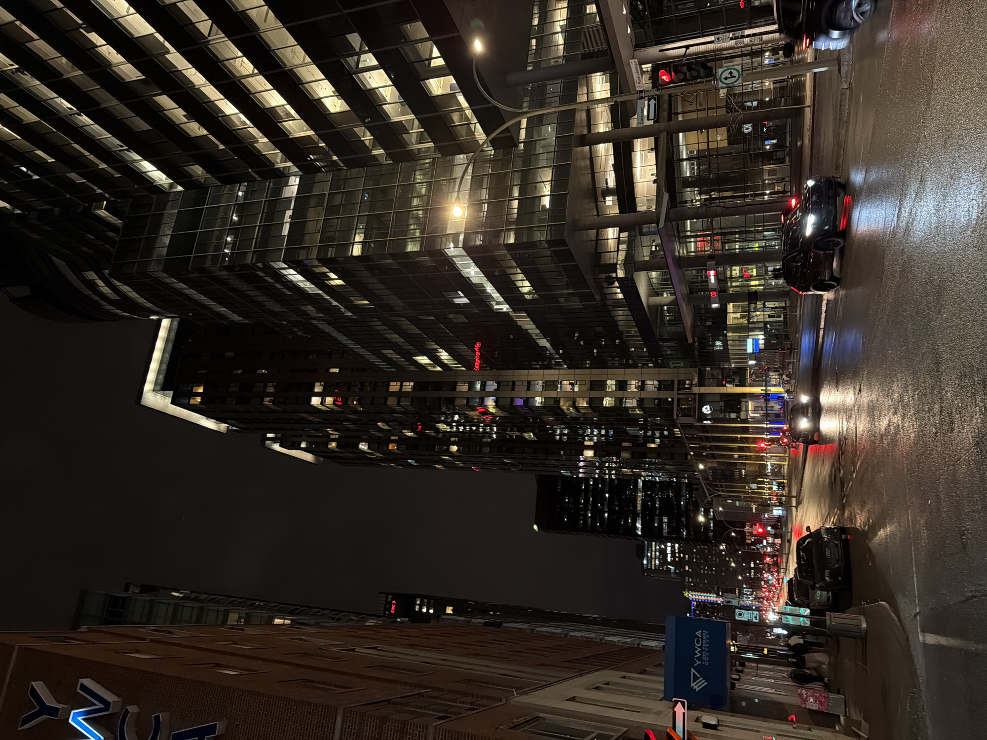 Wet Montreal streets reflect city lights during early morning hours