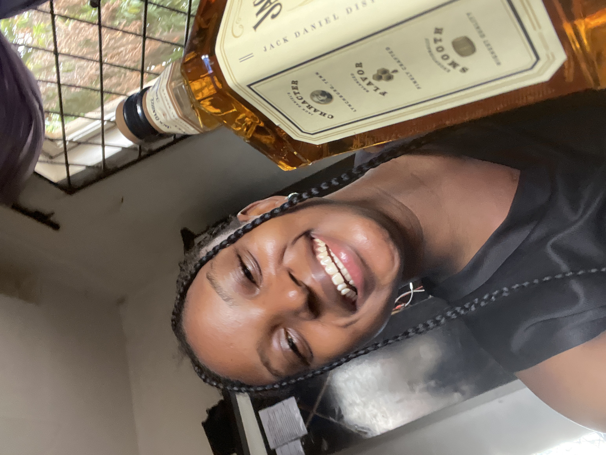 Woman poses with whiskey bottle in selfies in Lokoja