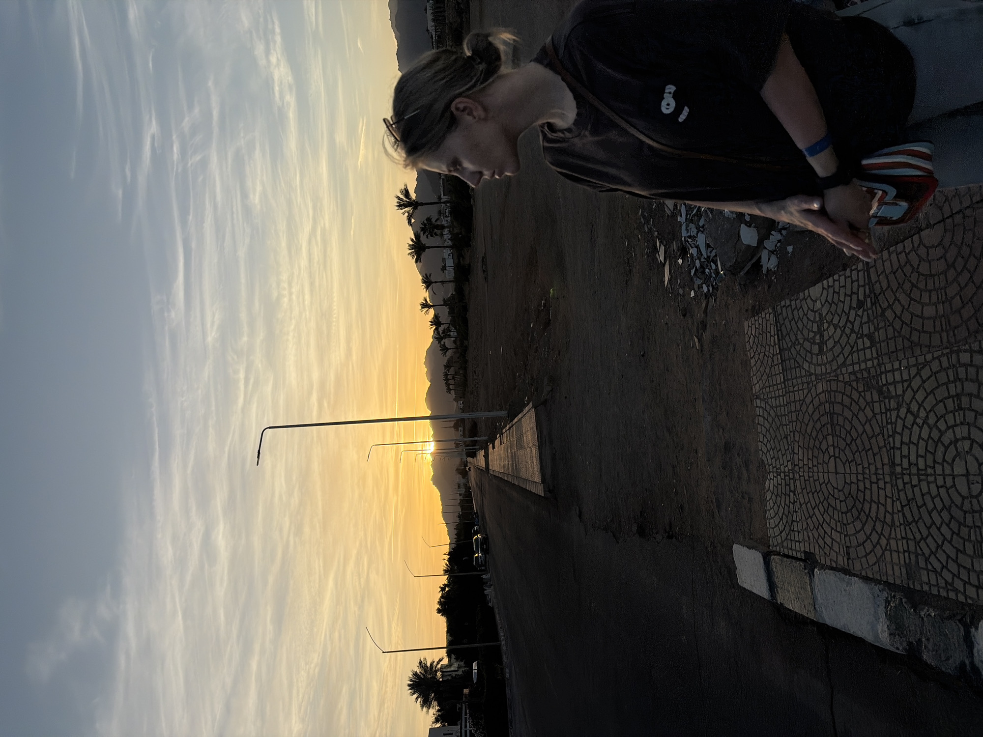 Tourists photograph sunset moments on Sharm El Sheikh street