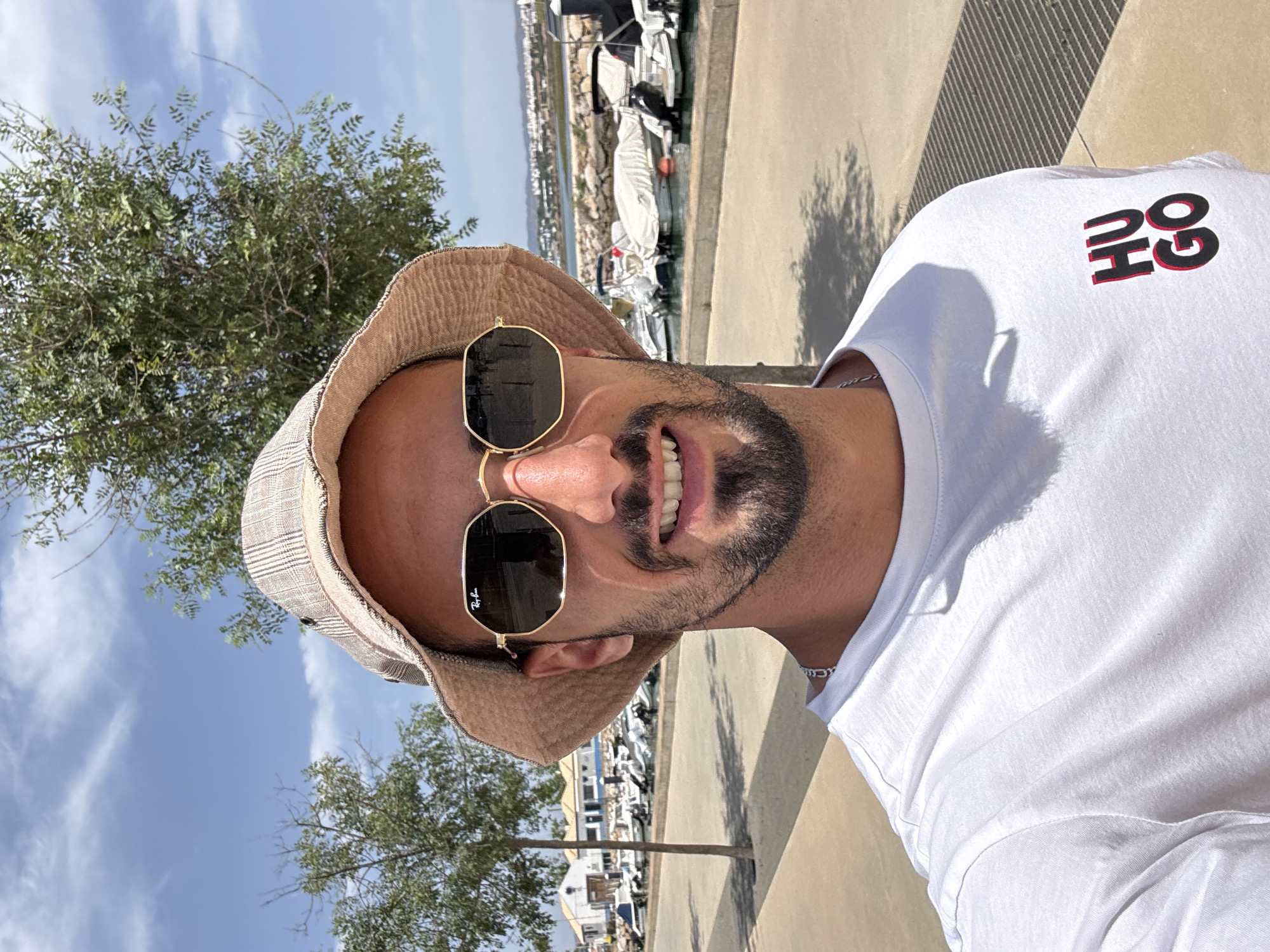 Man in HUGO shirt, bucket hat spotted outdoors