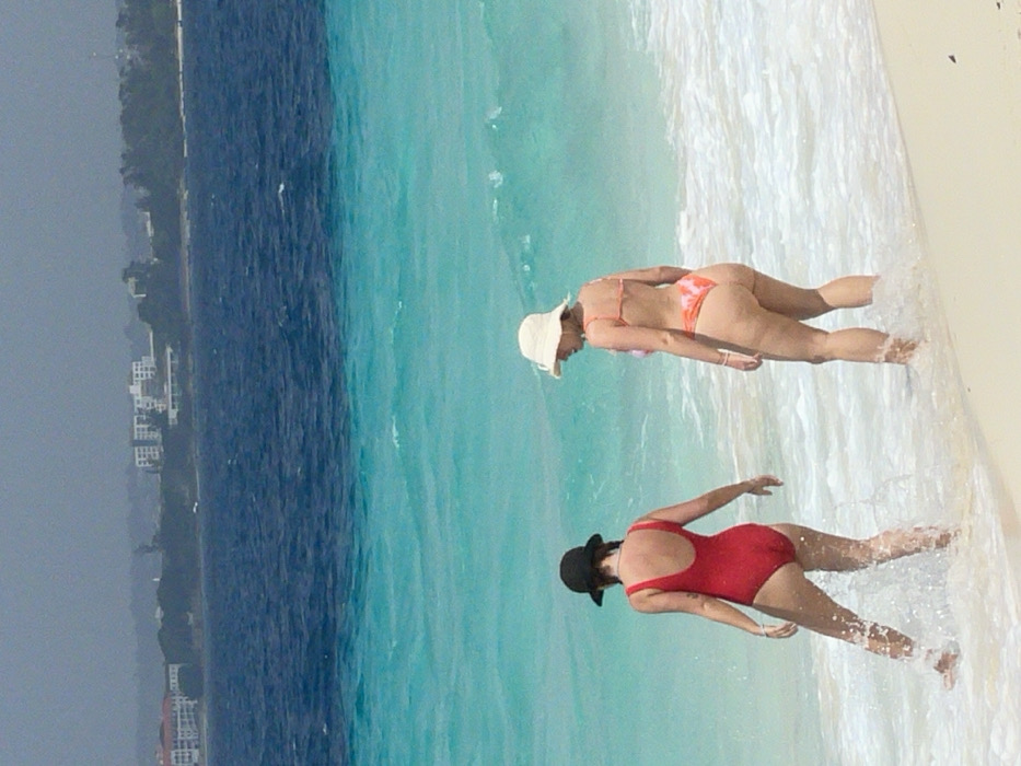 Beachgoers enjoy sunny morning activities on Zanzibar shores