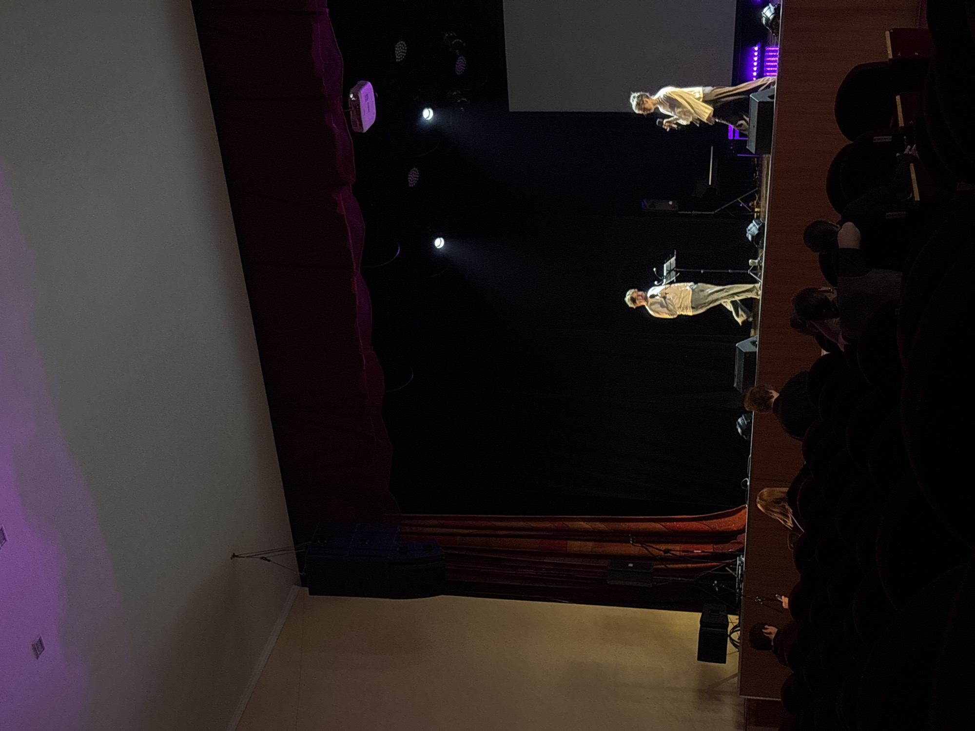 Stage performance with temperature theme message in Perm auditorium