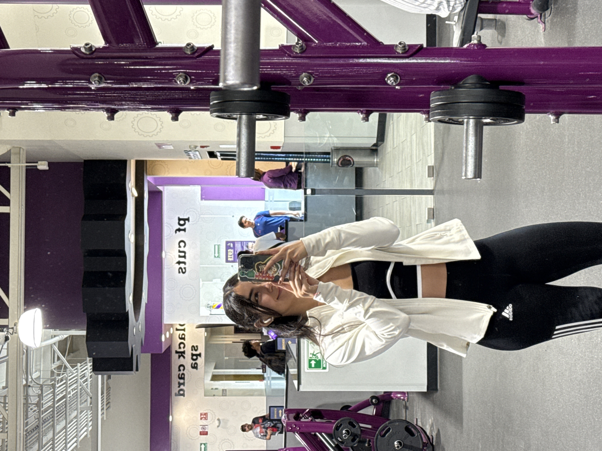 Woman takes selfie at Planet Fitness gym in Puebla