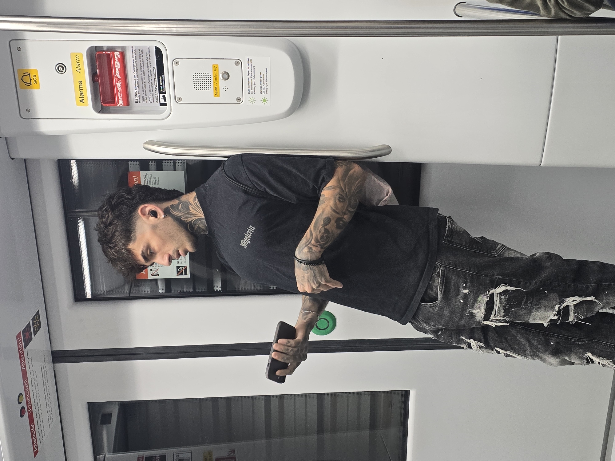 Tattooed commuter spotted on Barcelona Metro during morning rush