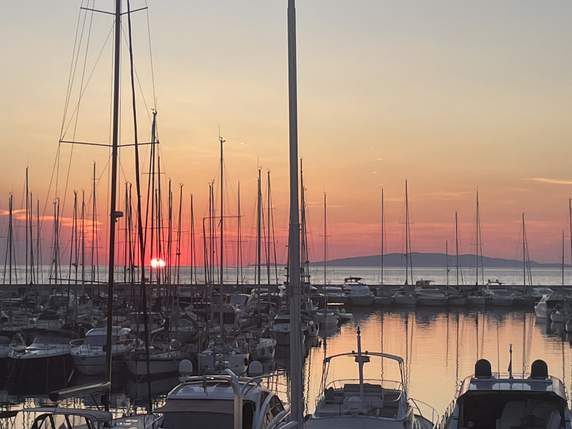 Golden hour settles over Punta Ala's marina