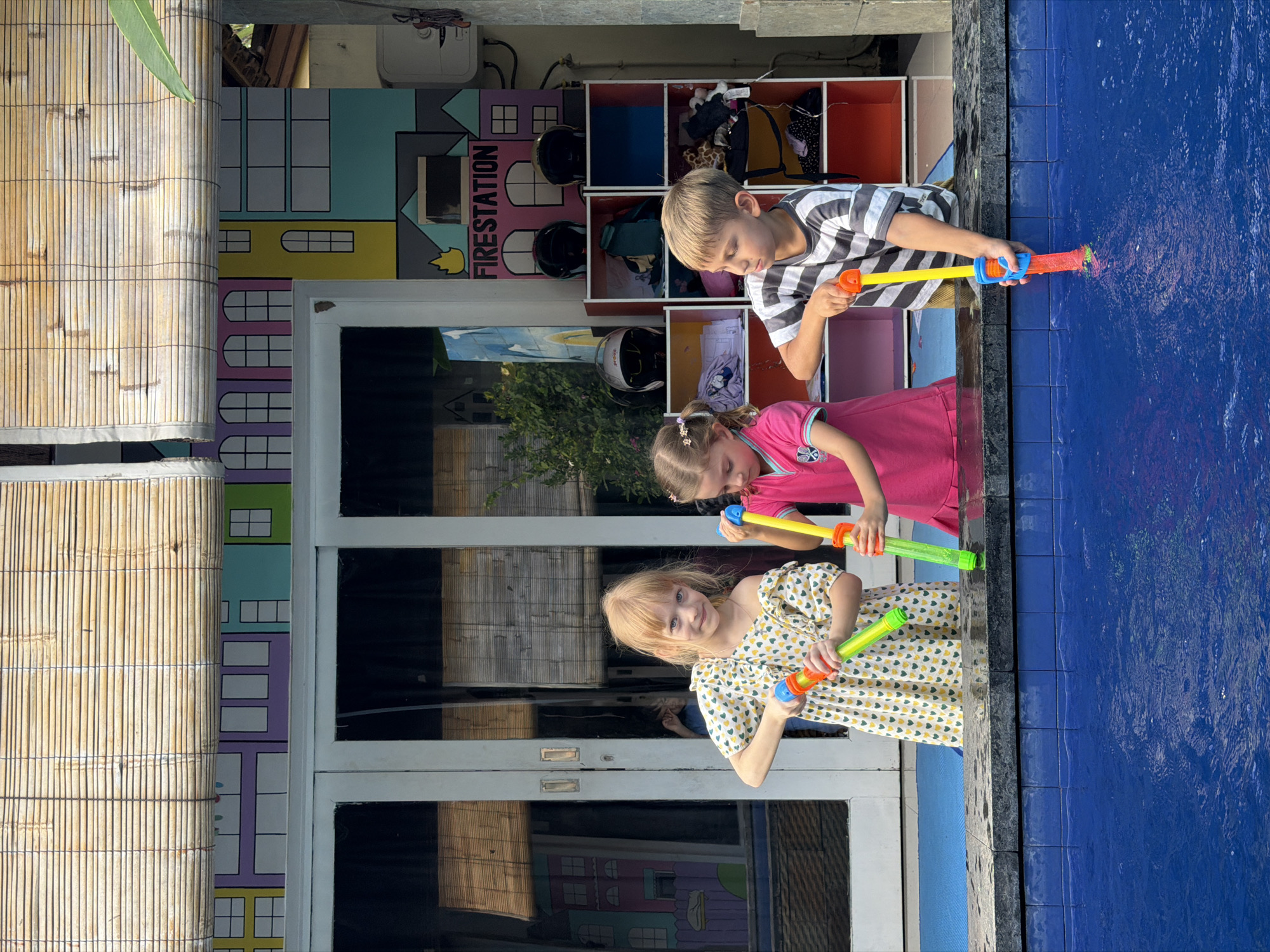 Children play with water guns at Kuta daycare facility