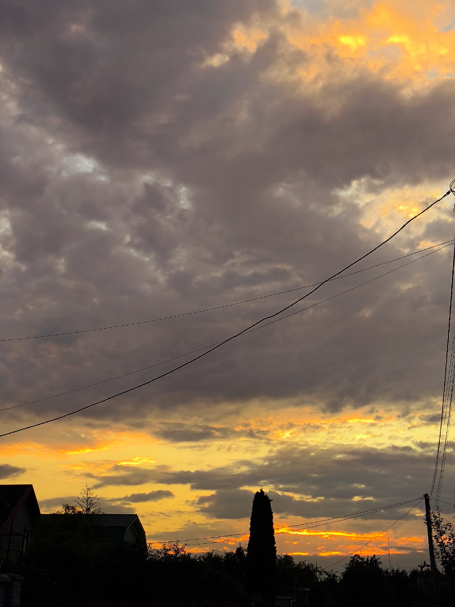 Kaliningrad sunset lights up the sky over rooftops and power lines