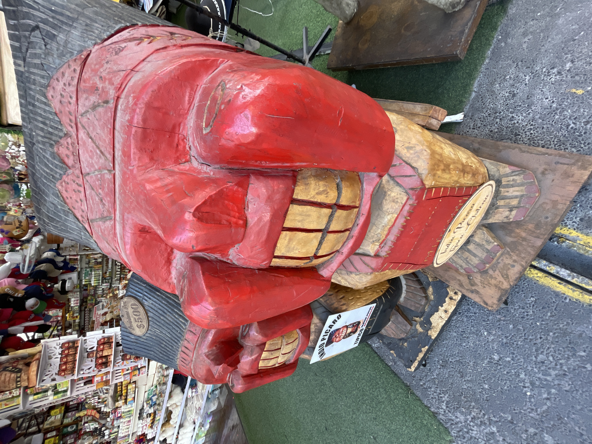 Hand-carved wooden sculpture displayed at Iquique market stall