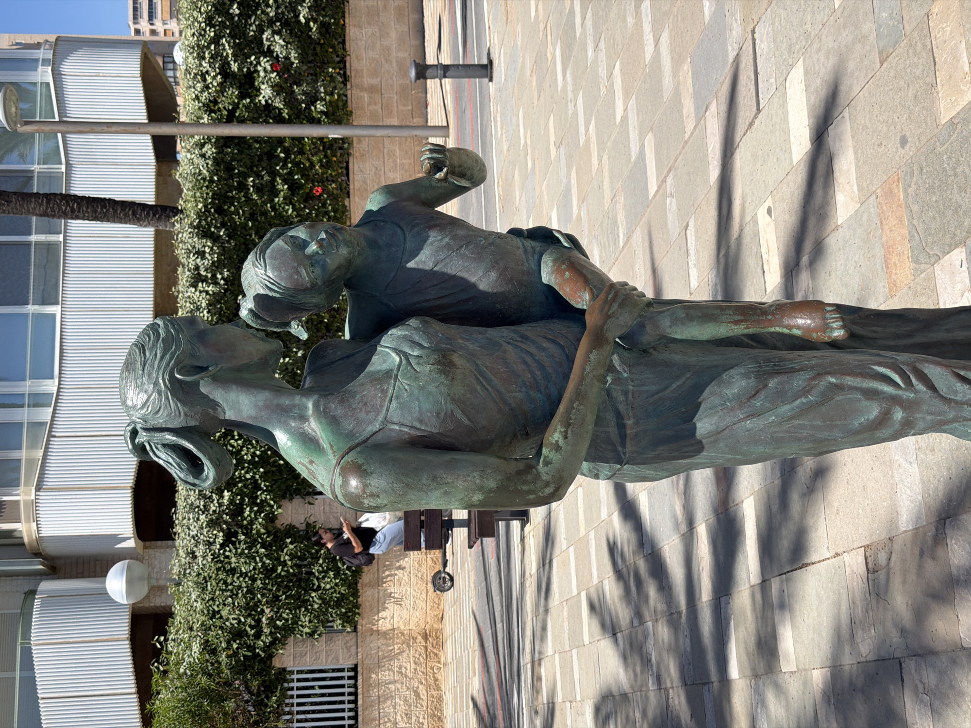 Woman walks beachfront promenade in sunny Alicante