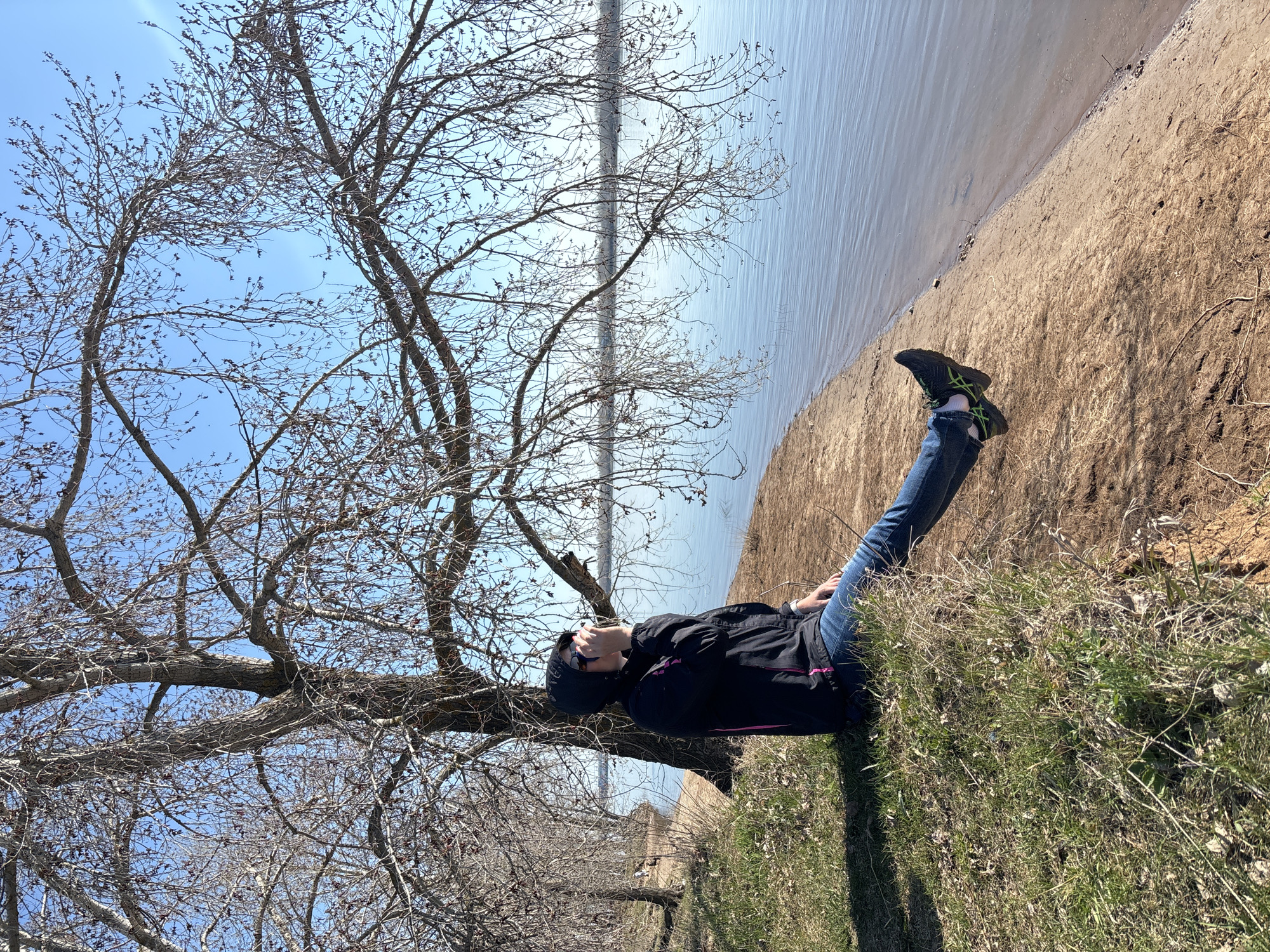 Person rests by water in Chaikovsky, Russia