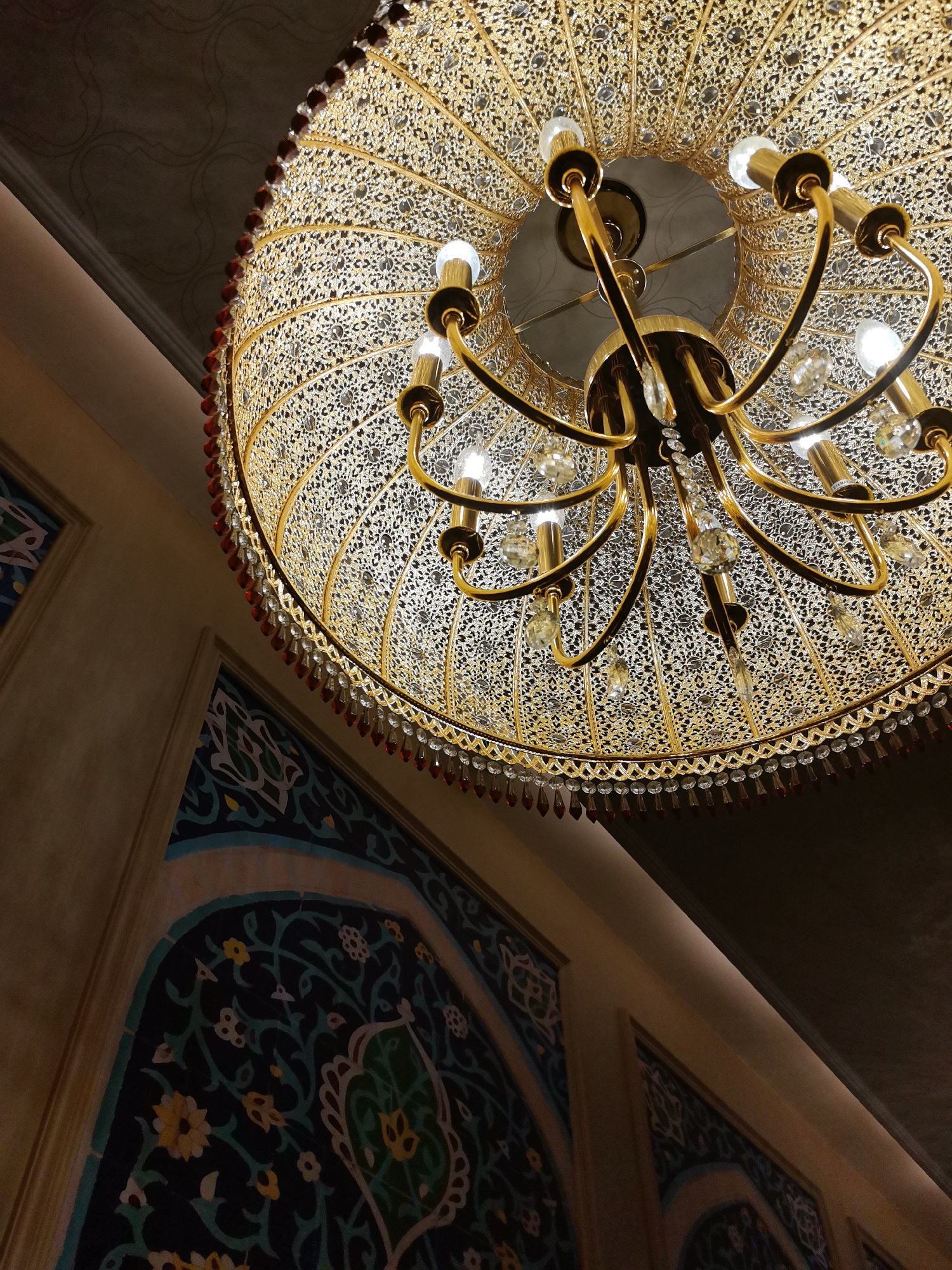 Chandelier, floors, and fried snacks in an ornate interior