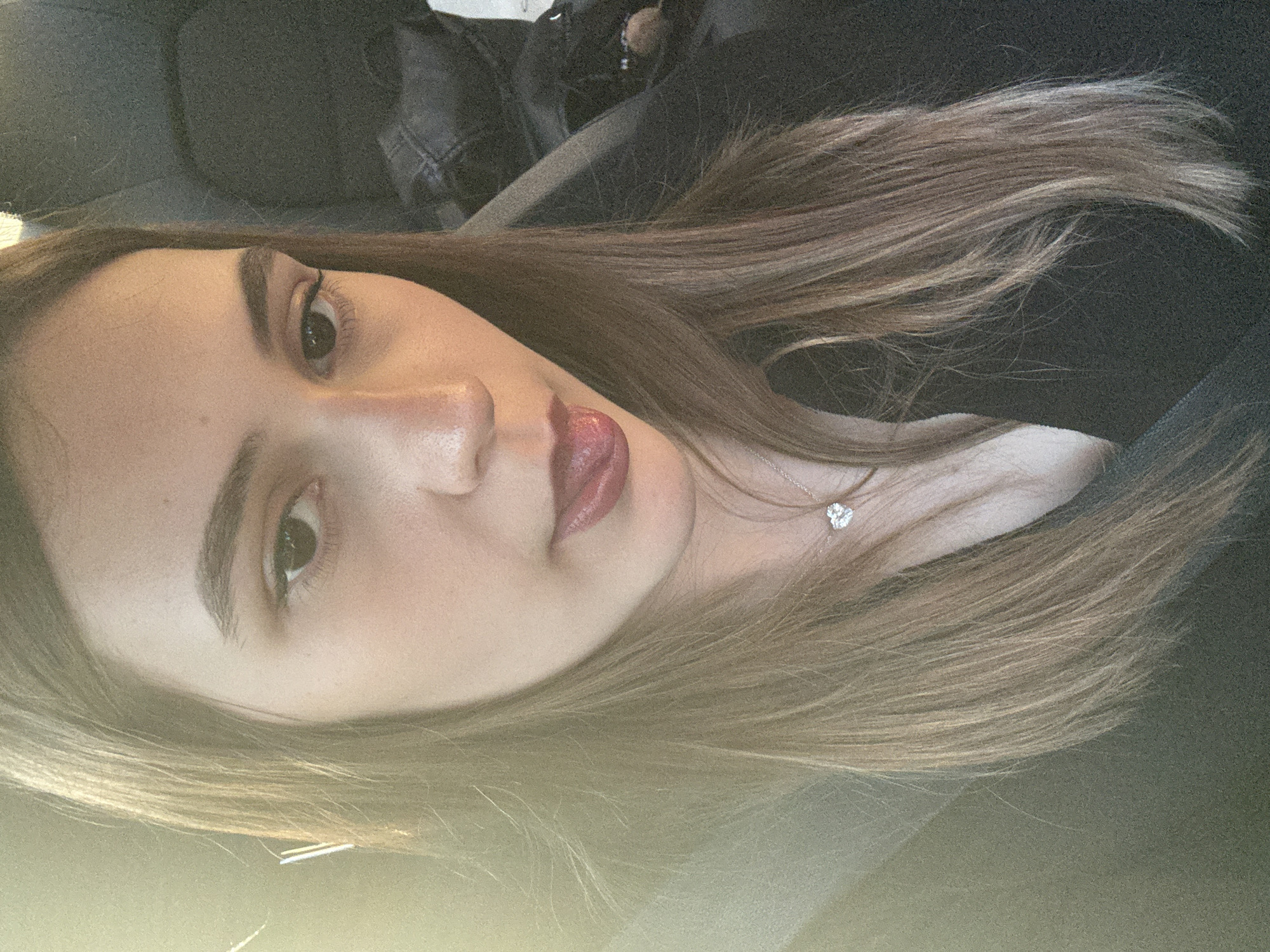 Woman photographed in car wearing silver necklace in Baden-Baden