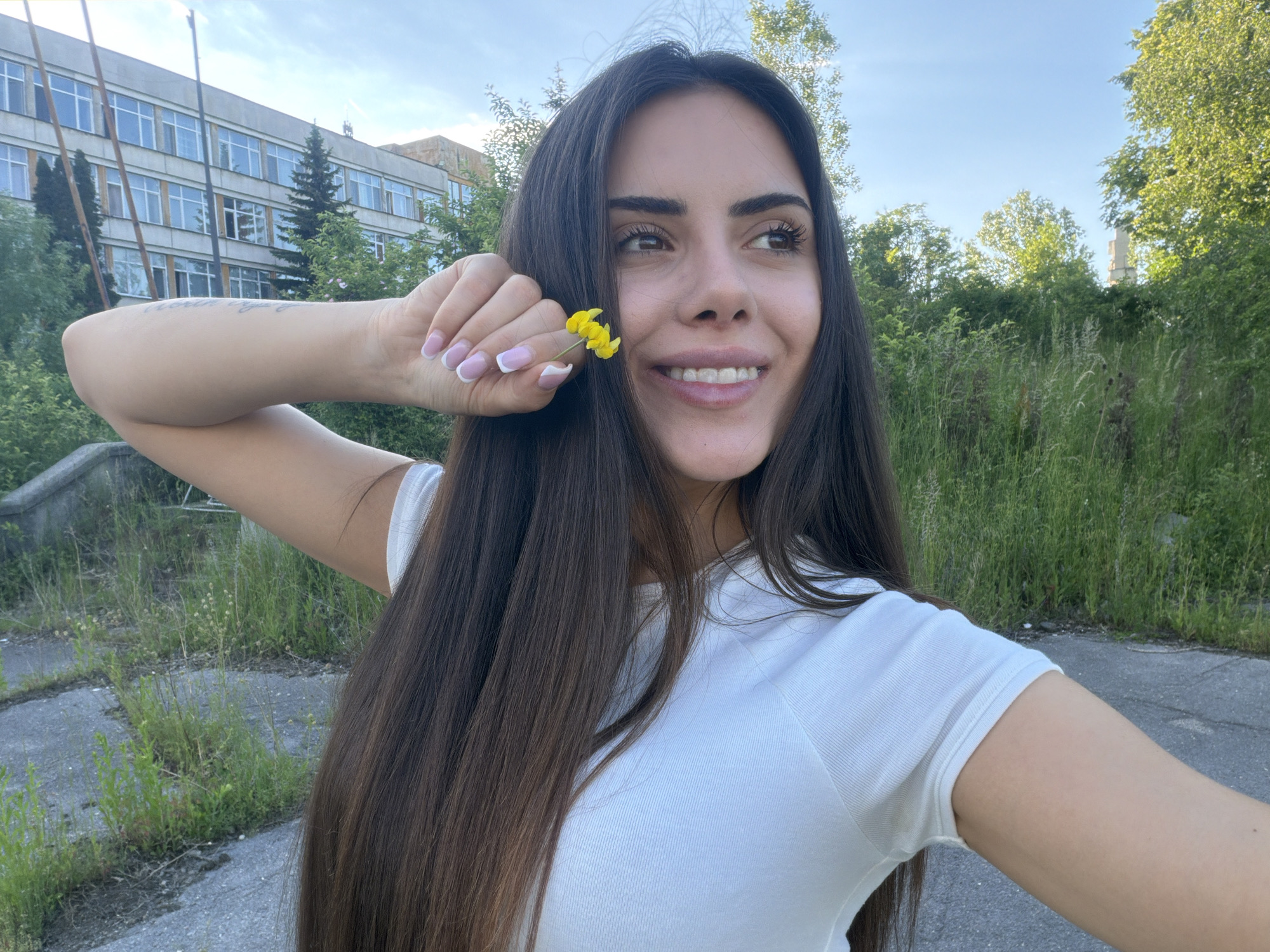 Woman takes flower selfies in Sofia park area