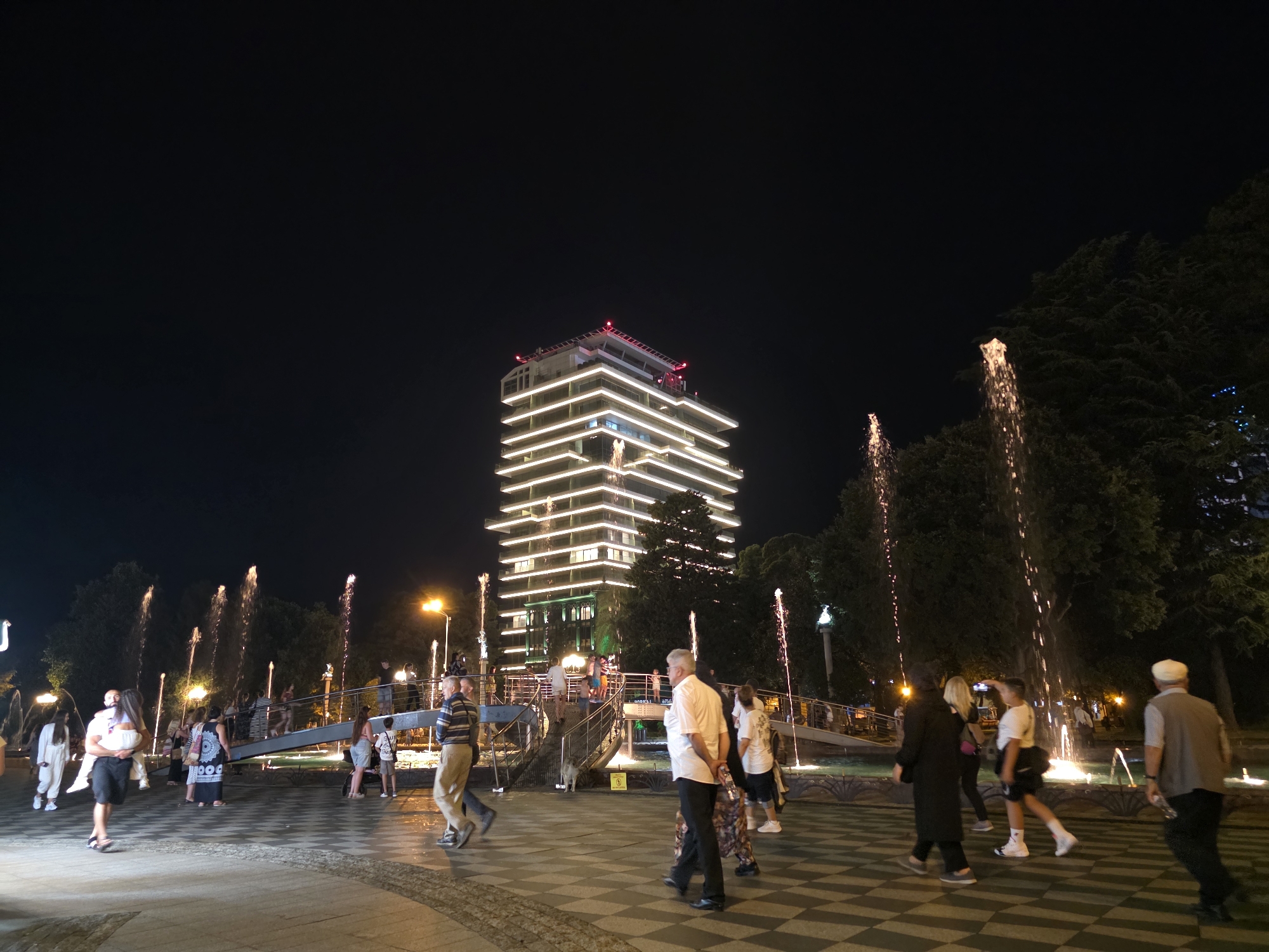 Batumi promenade at night: fountains, lights, crowds