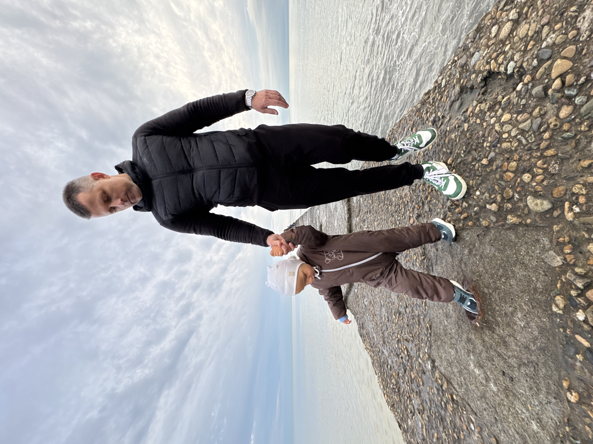 Family enjoys afternoon outing on Sochi's pebble beach