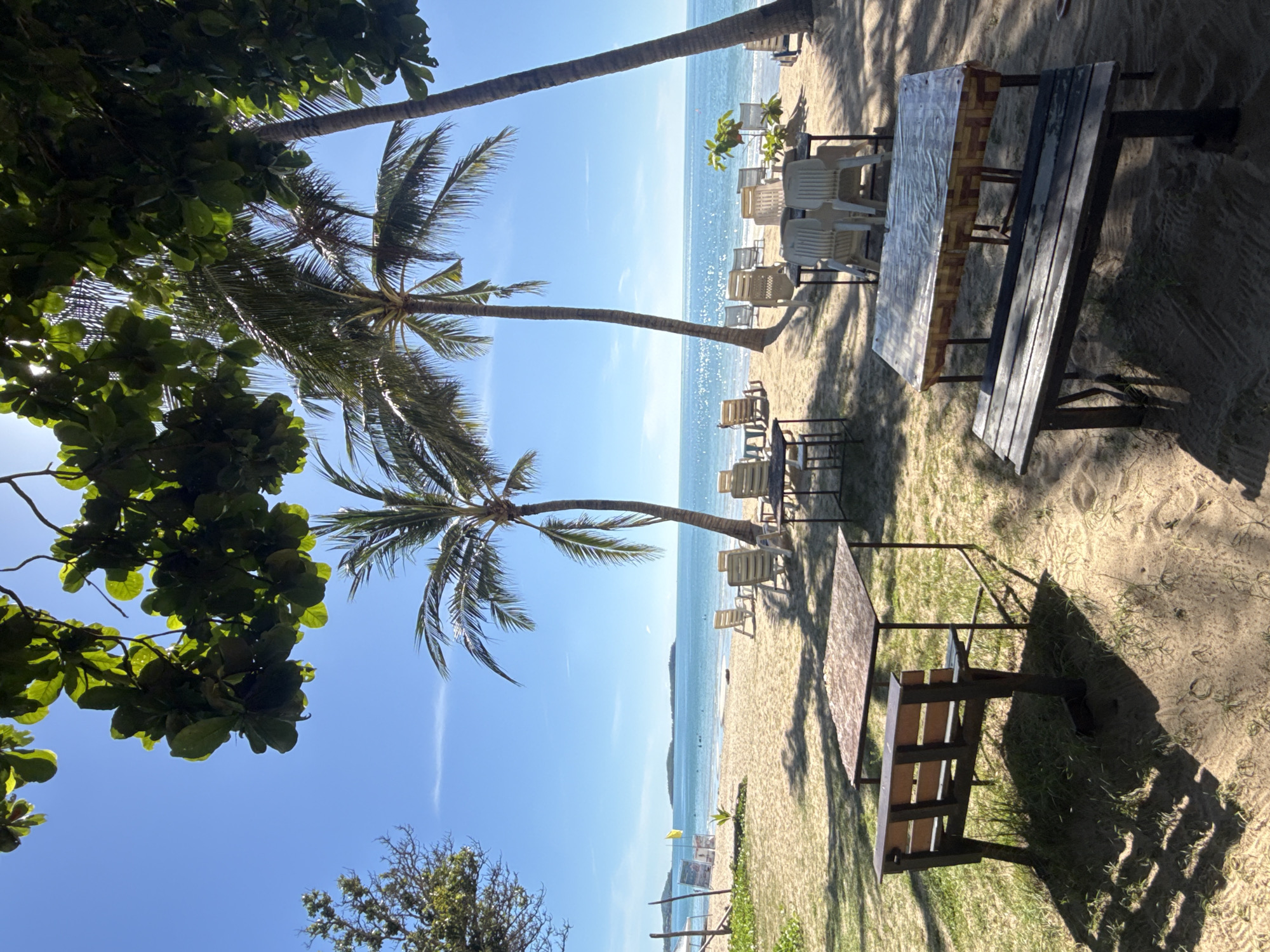 Beach morning in Chaweng Noi: breakfast, shoreline, and a crane crew at work