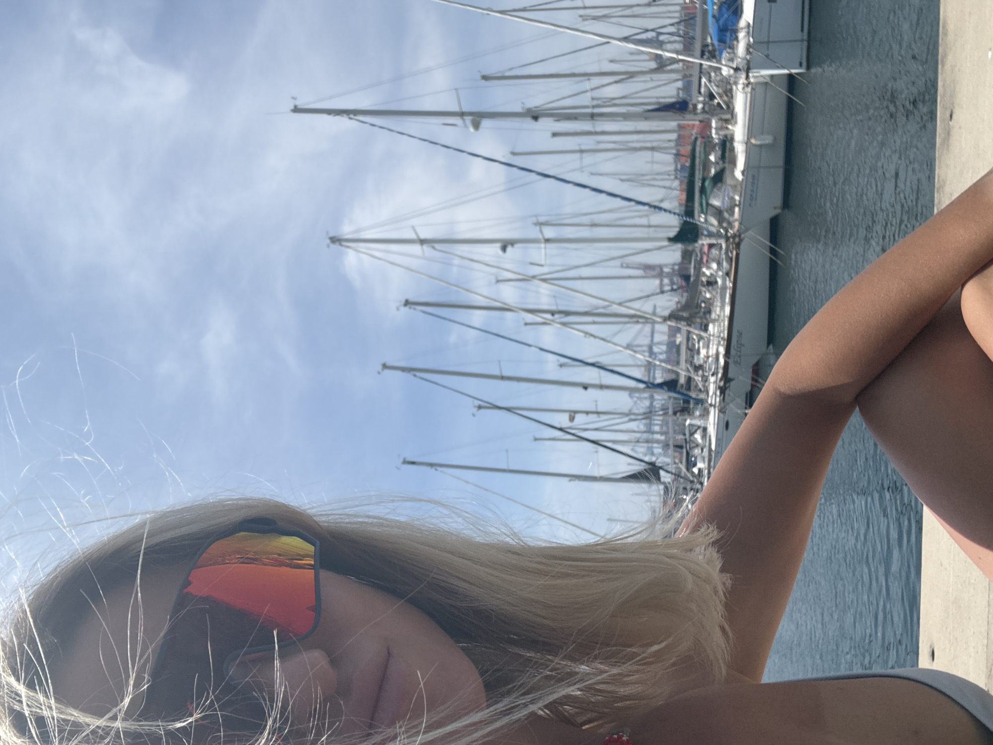 Person relaxes by Valencia marina on sunny morning