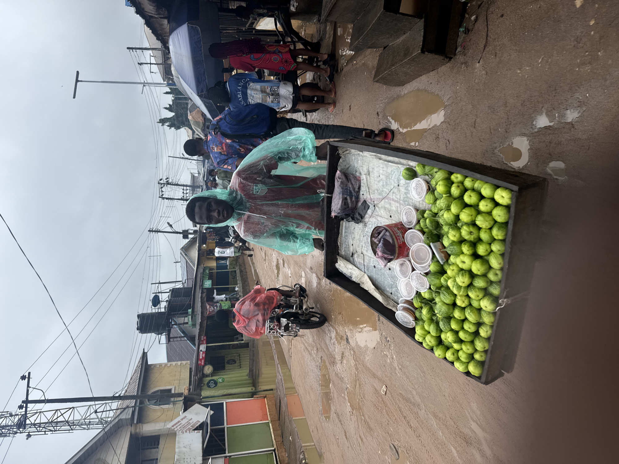 Street vendor sells green produce from wooden cart in Ihiagwa