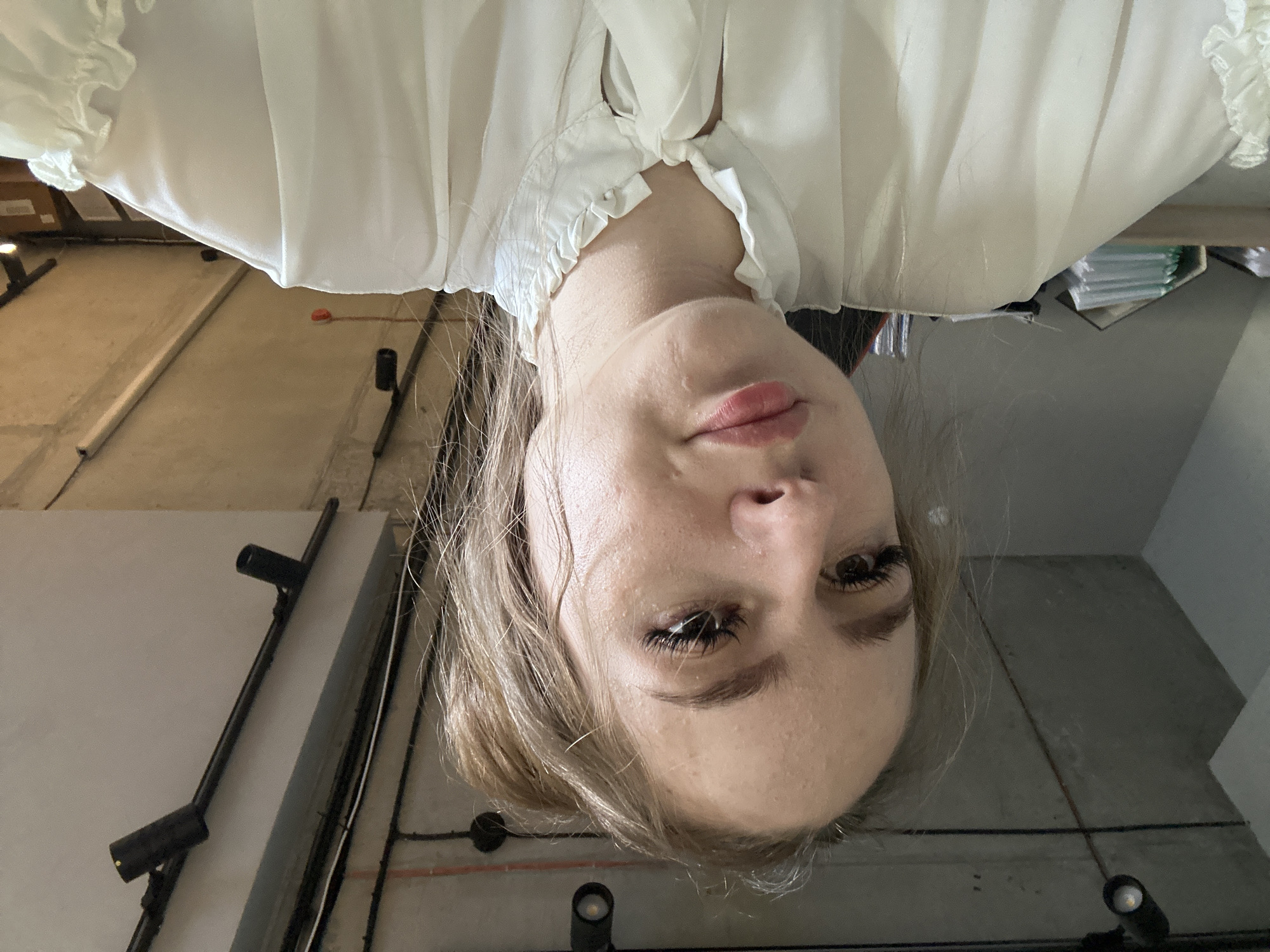 Multiple selfies in an office, white ruffled blouse, gaming chair