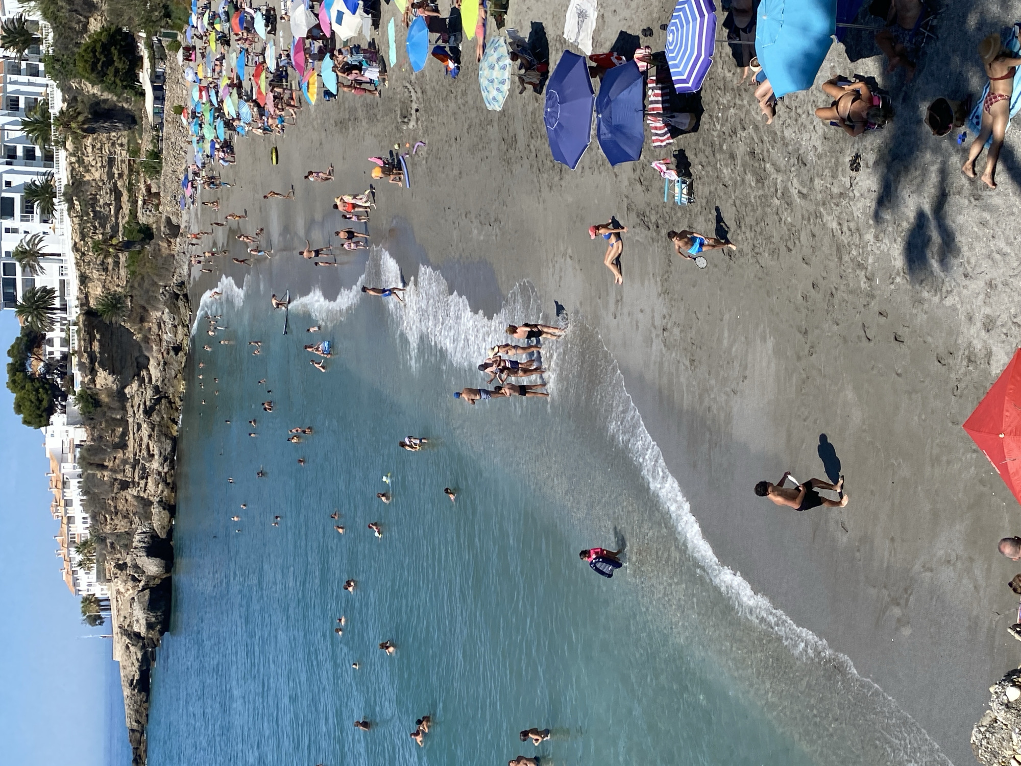 Crowded summer beach day on the Nerja coastline