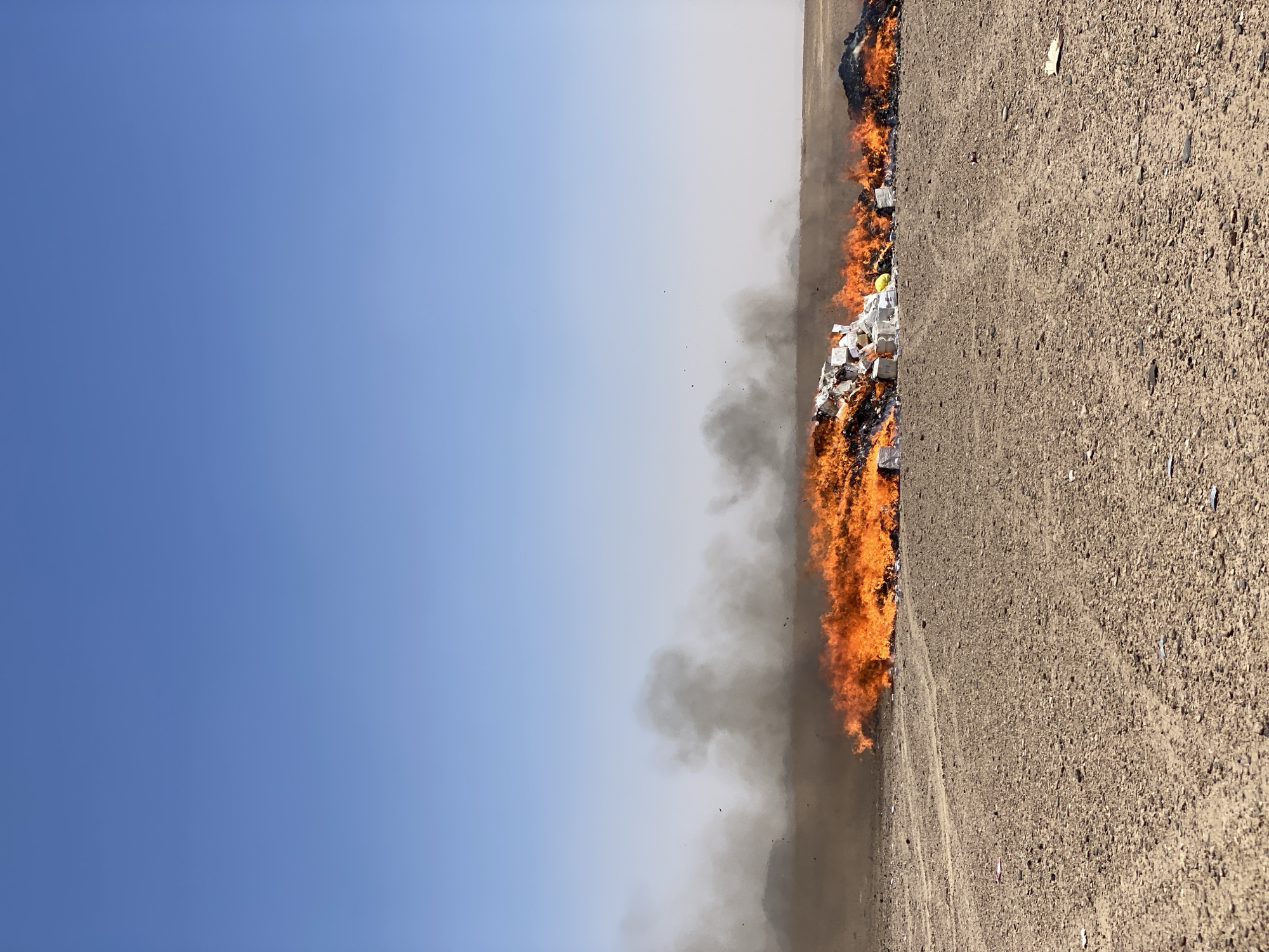 Waste fire burns in arid Daman, Afghanistan