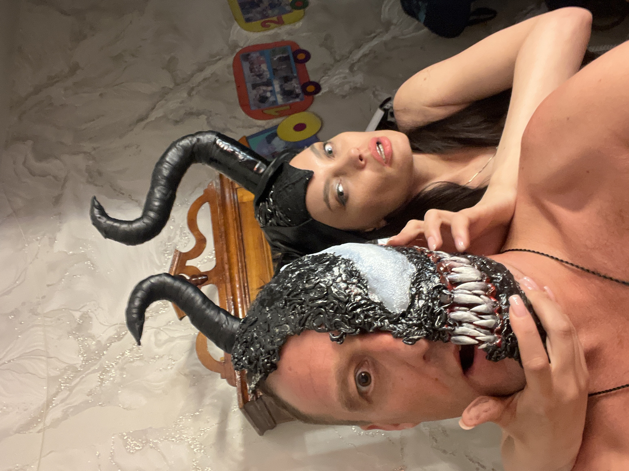 Venom mask and demon horns cosplay at home in Perm