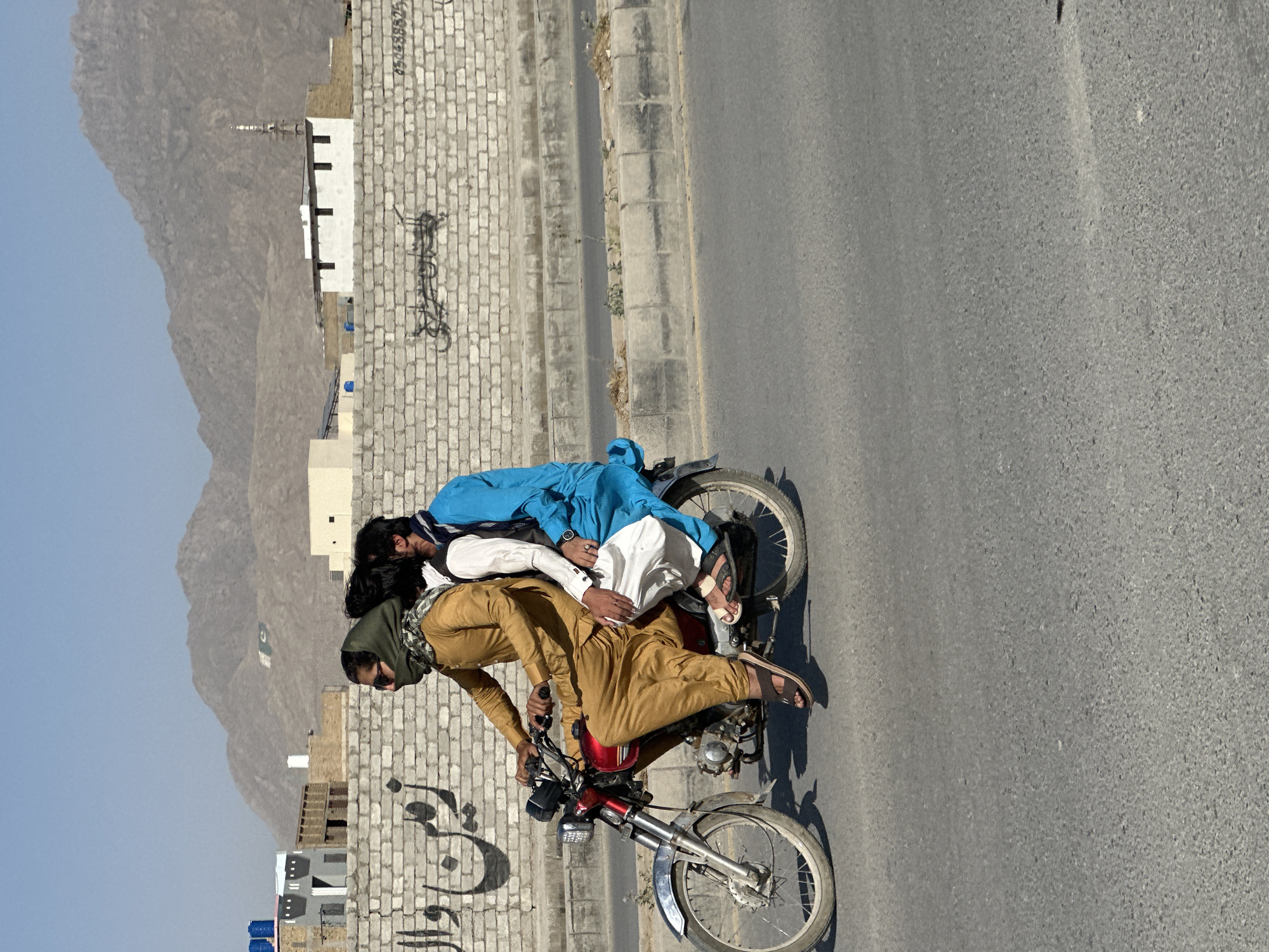 Three people spotted on red motorcycle in Quetta