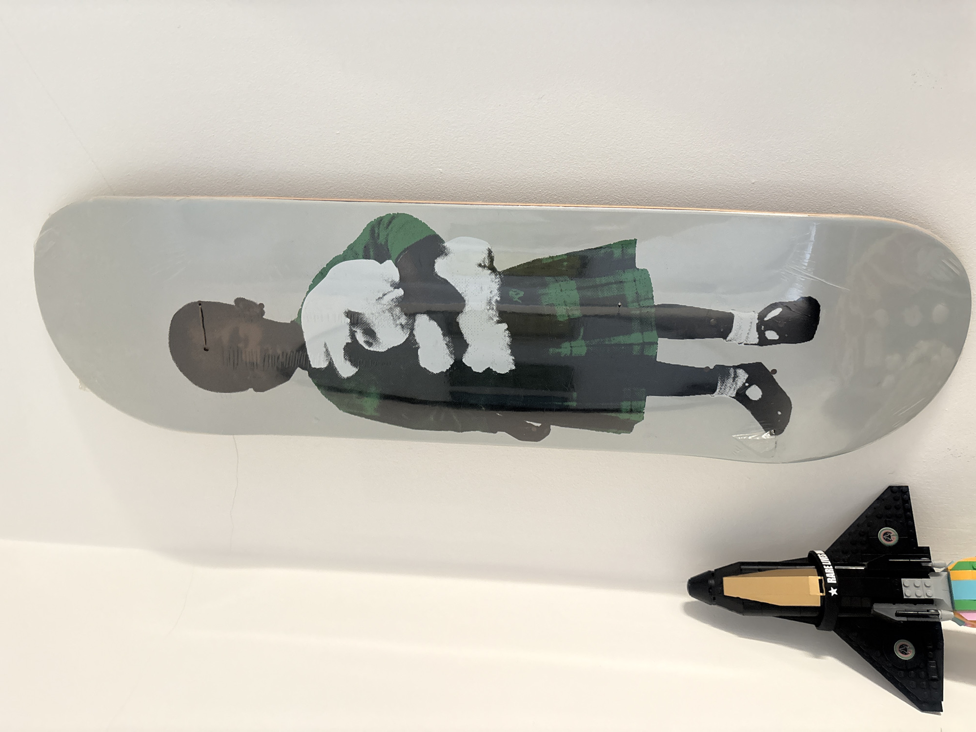 Skateboard and LEGO spaceship spotted arranged on London shelf
