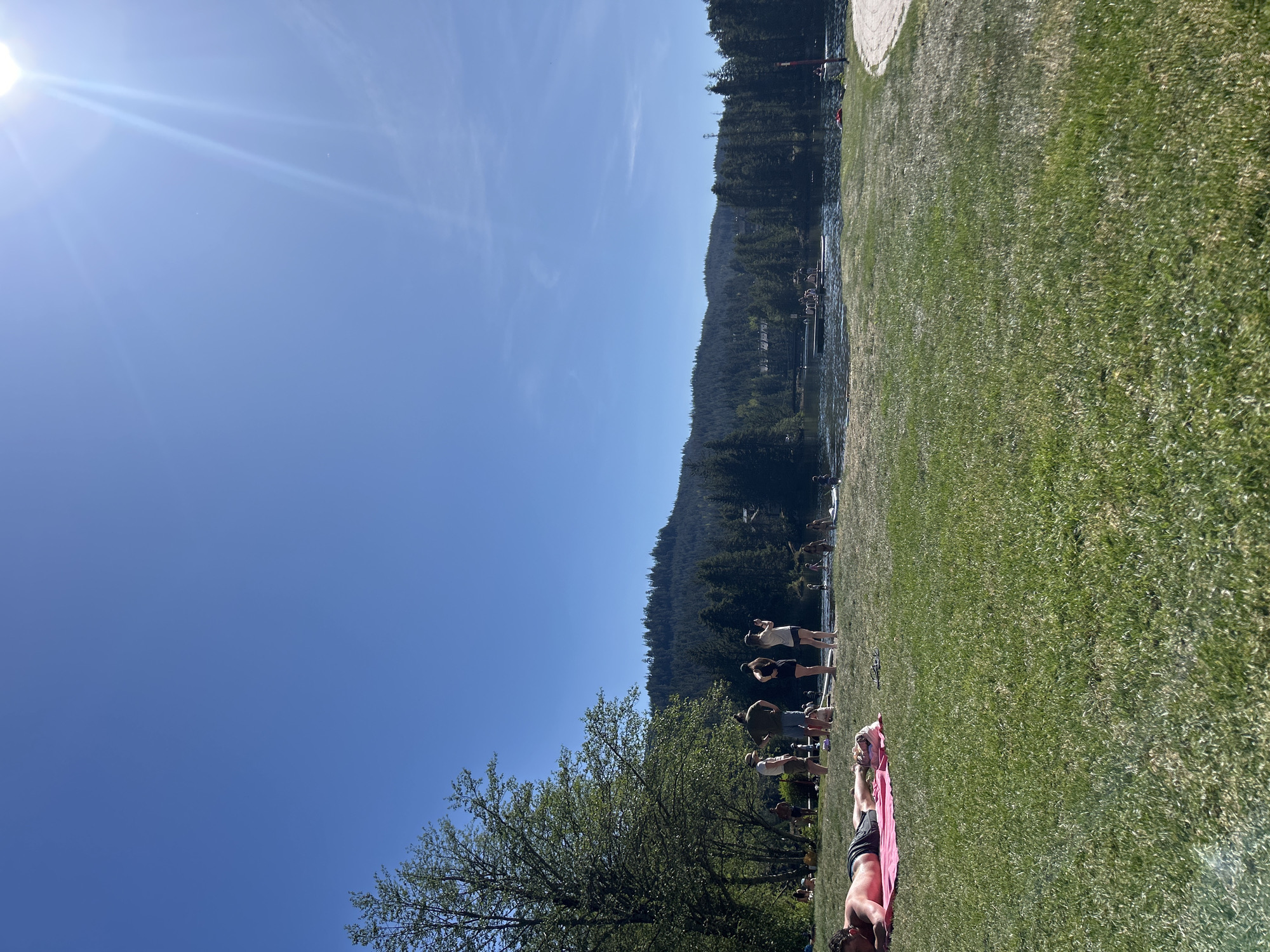 Group gathers at Whistler lake during late evening sunshine