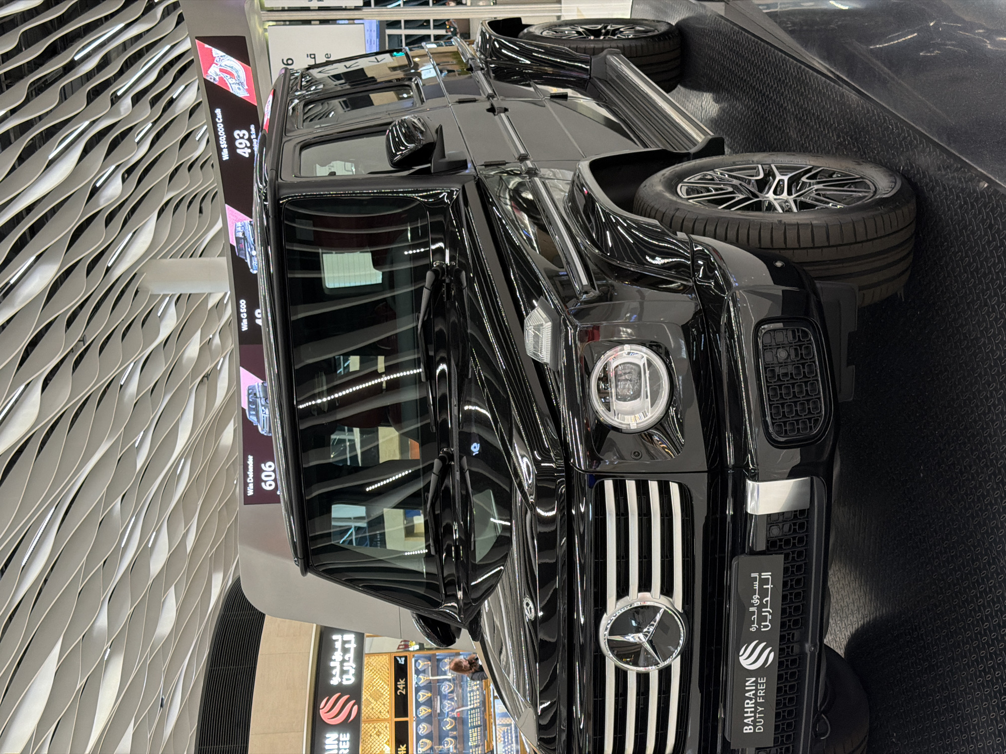Luxury car display, modern interiors documented at Bahrain airport