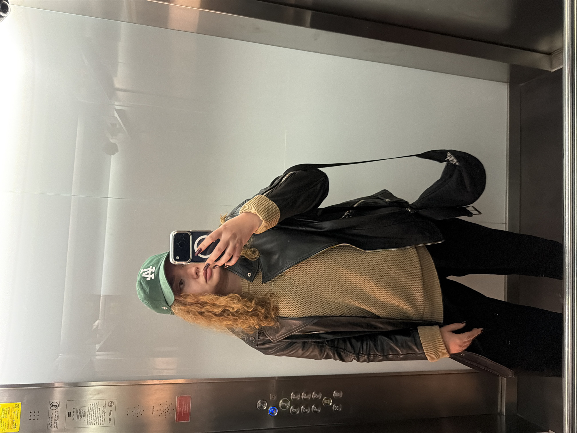 Person takes elevator selfie in Al Jizah, Jordan