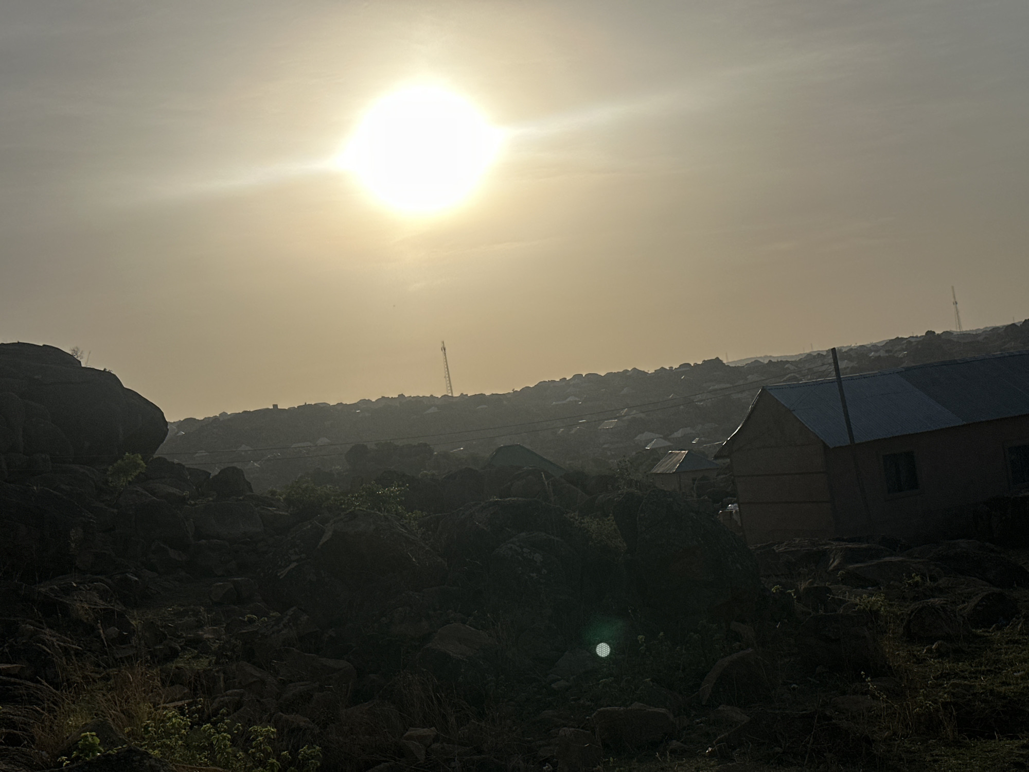 Bright sun creates glare over rocky Jos landscape