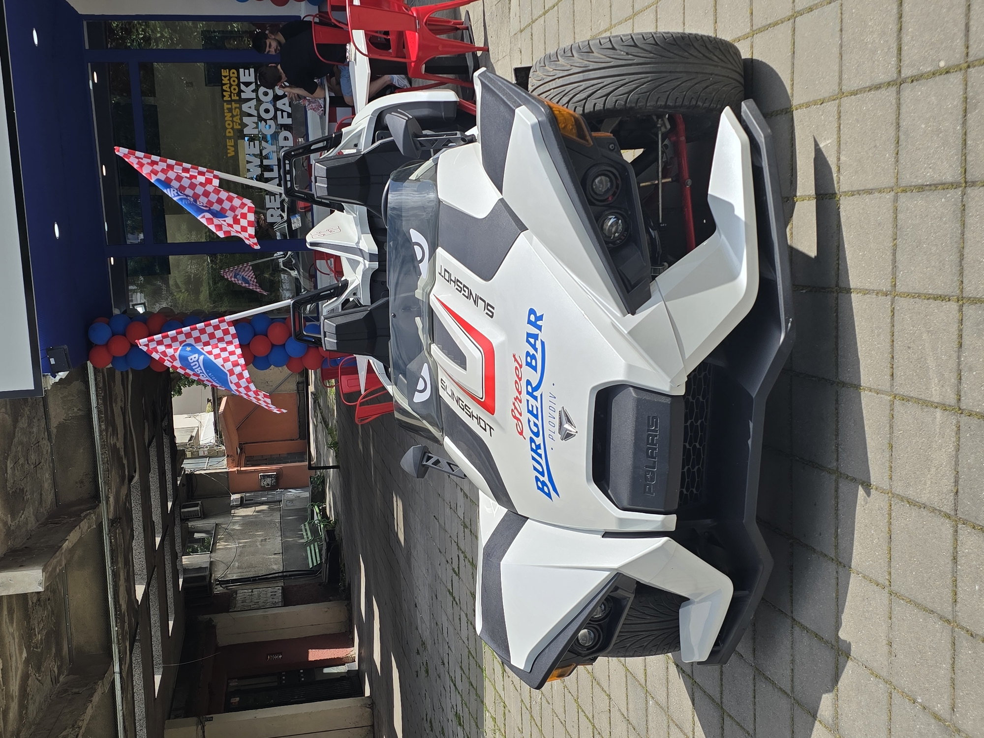 Polaris Slingshot three-wheelers spotted parked in urban commercial area