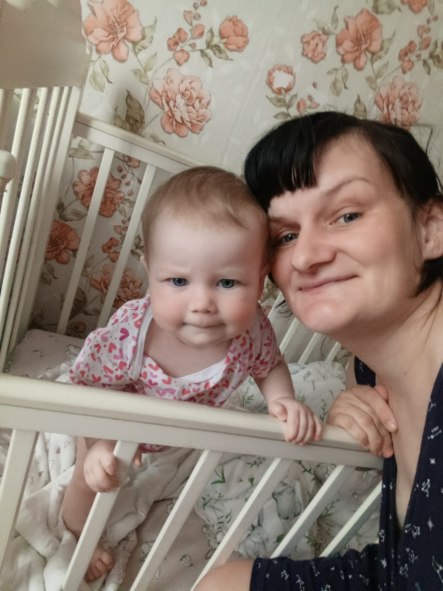 Woman and infant share quiet moments in nursery crib