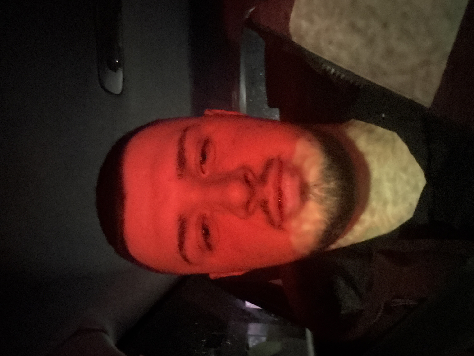 Man photographed under dramatic red lighting in Sofia