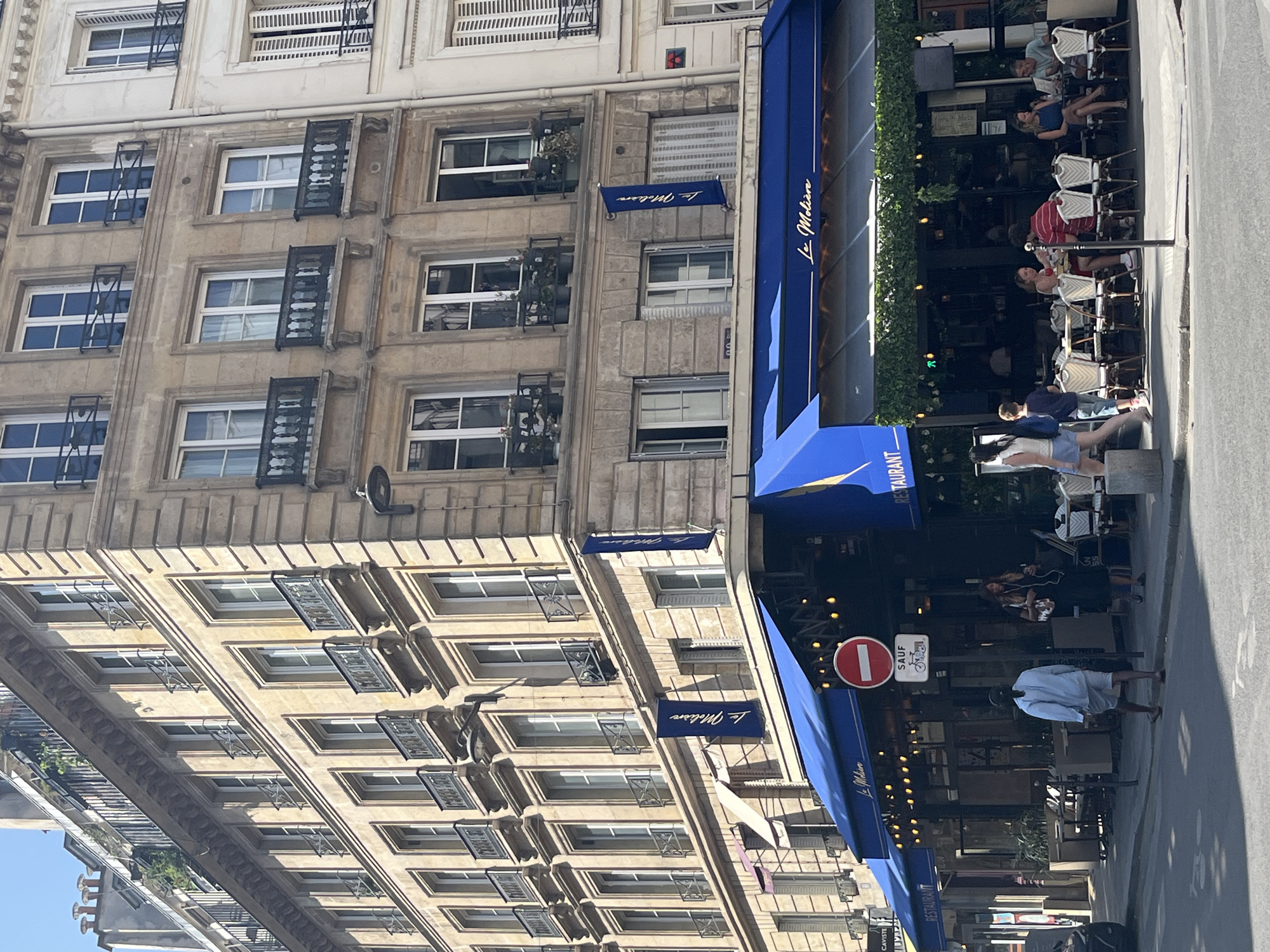 Blue-awninged café terrace on a Paris street