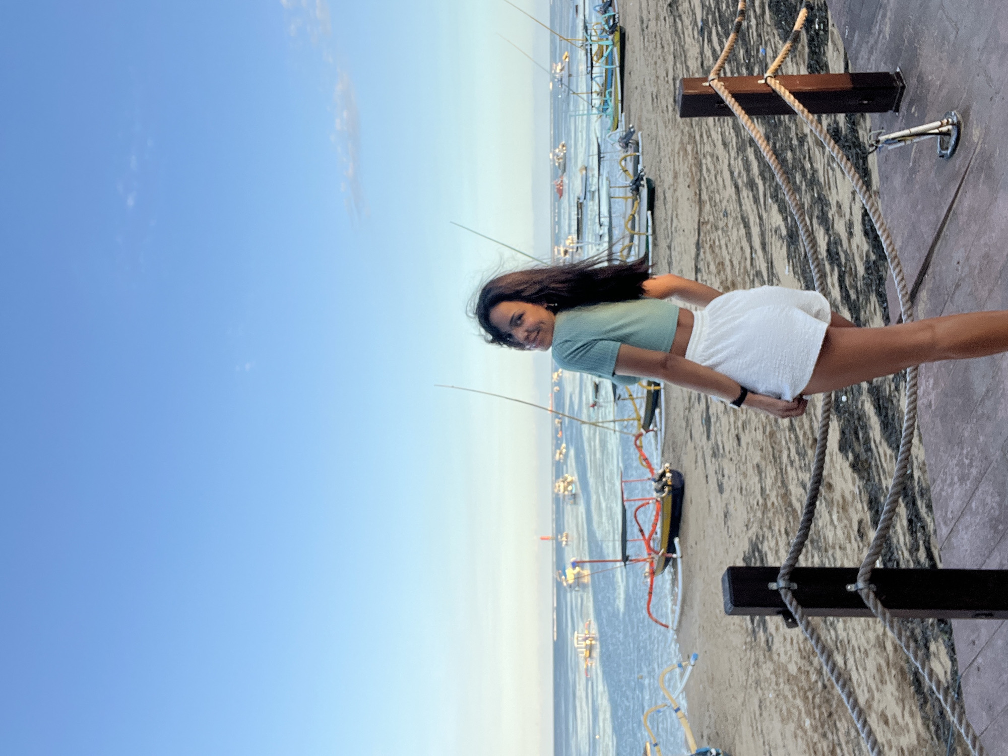 Woman poses for photos on Denpasar beach