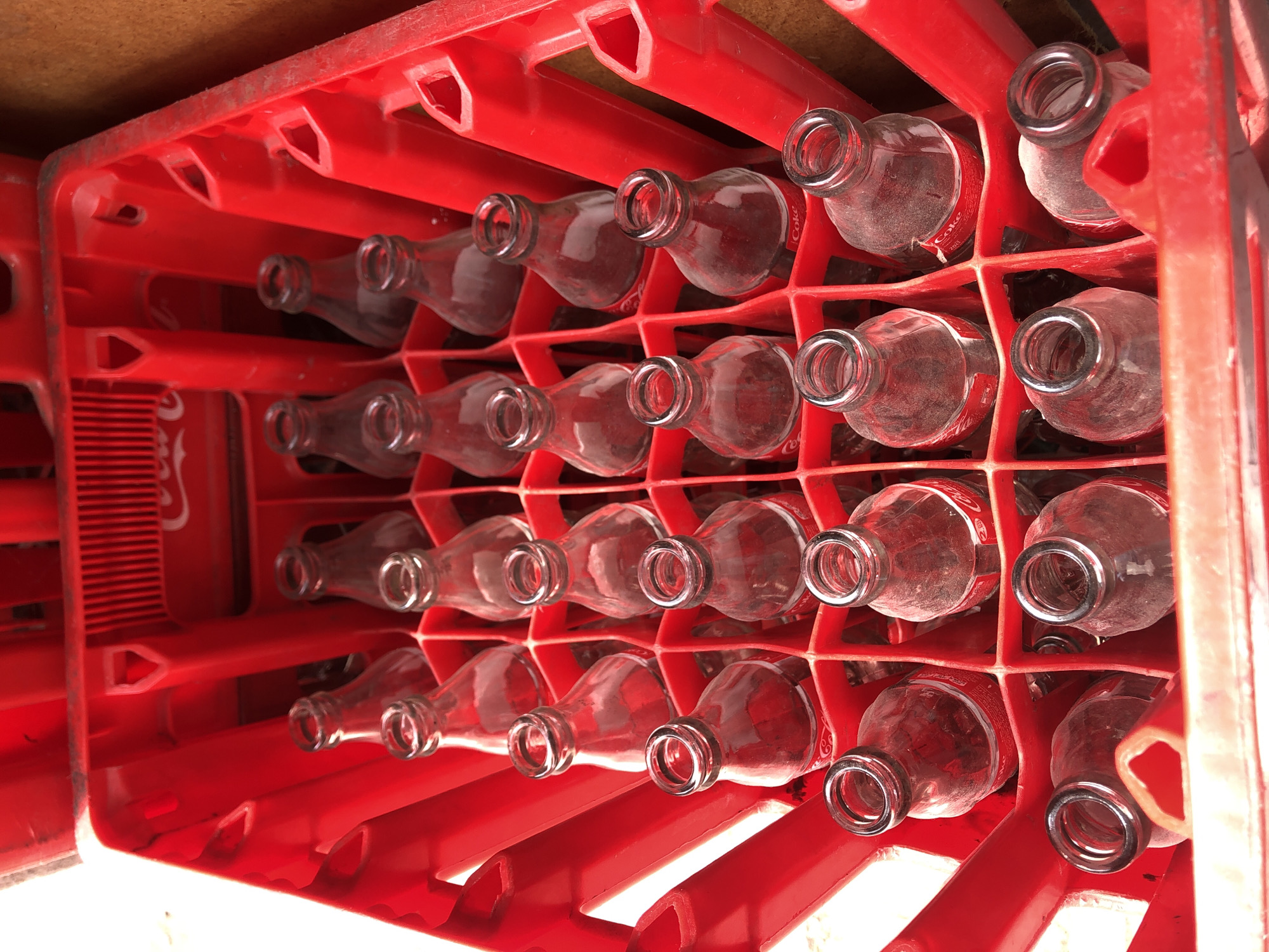 Empty Coke bottles in red crate observed in Casablanca