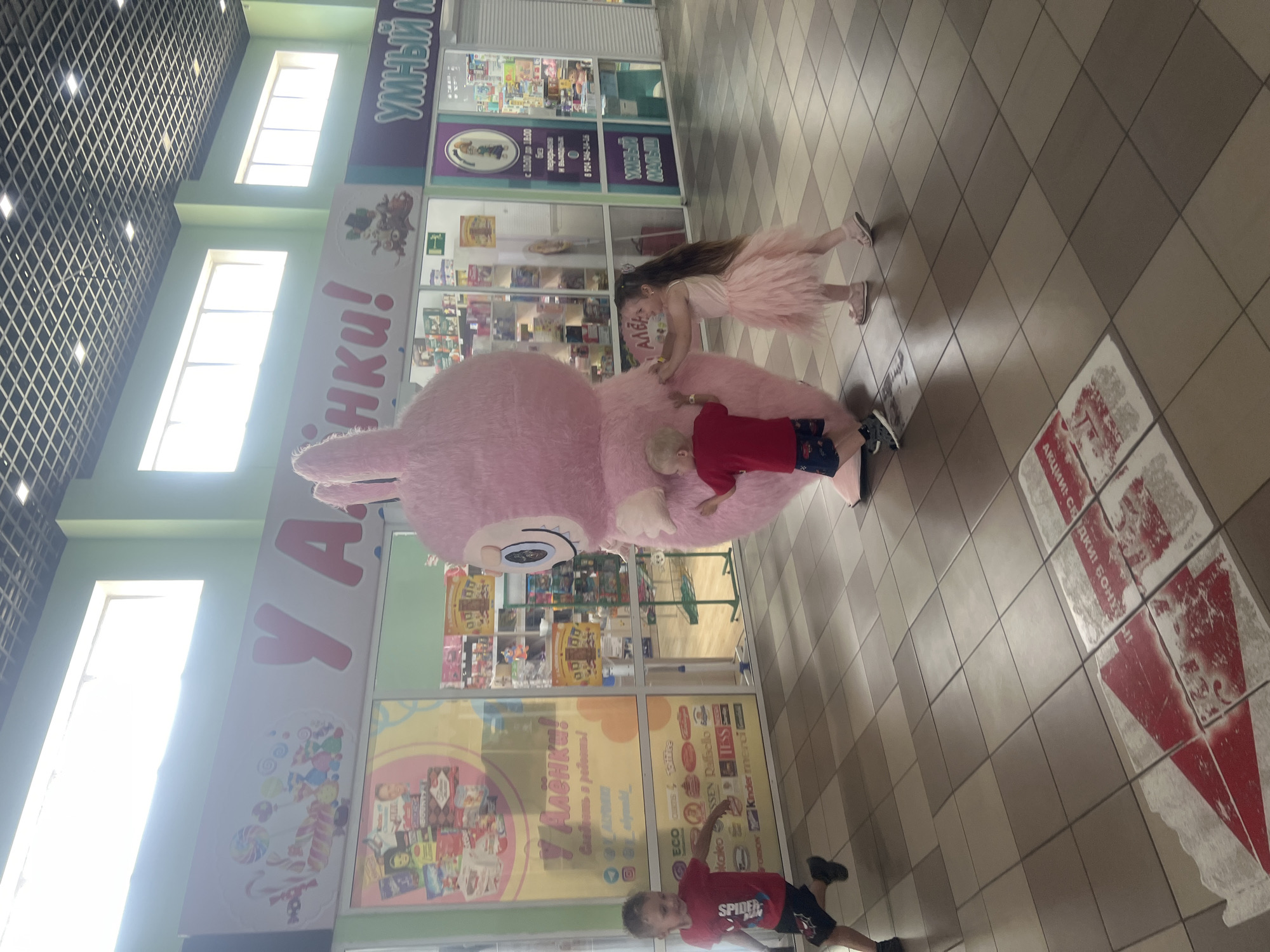 Pink bunny mascot meets the mall crowd at a beauty store