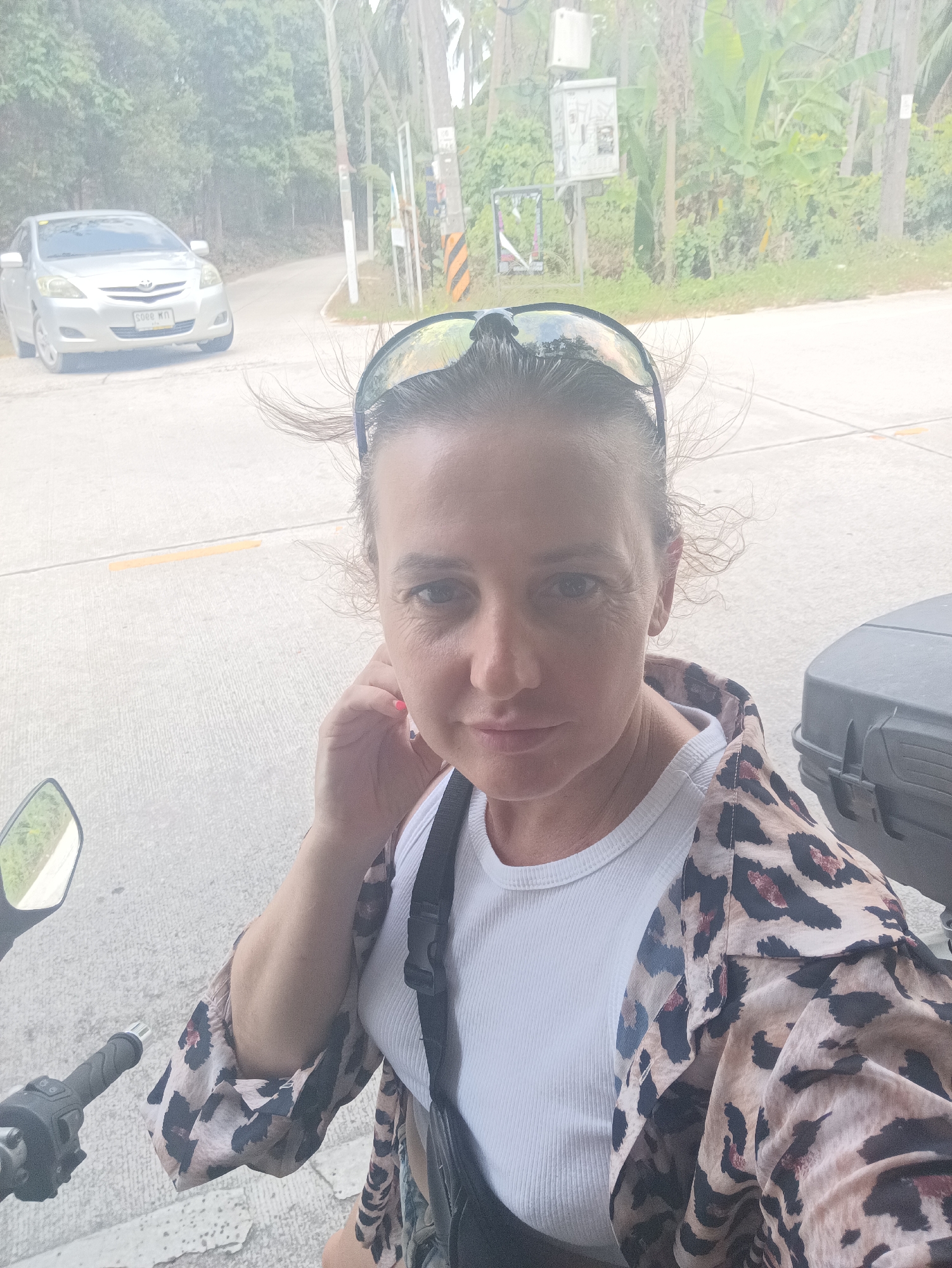 Woman takes selfie in leopard-print jacket in Thong Sala