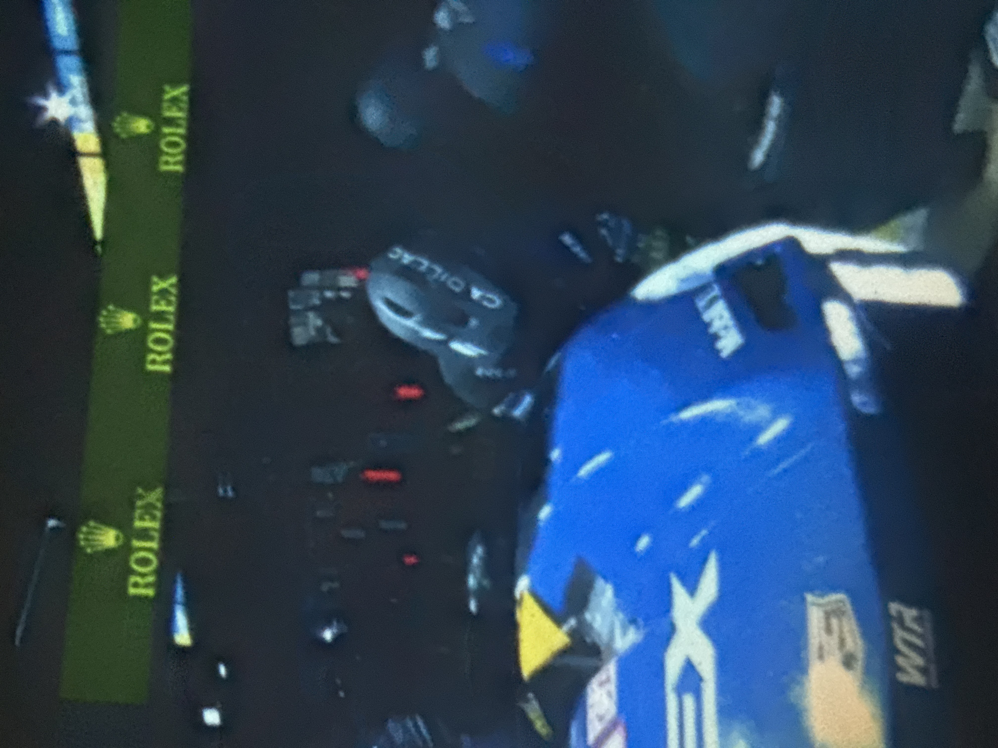 Night racing with blue Cadillac making pit stop