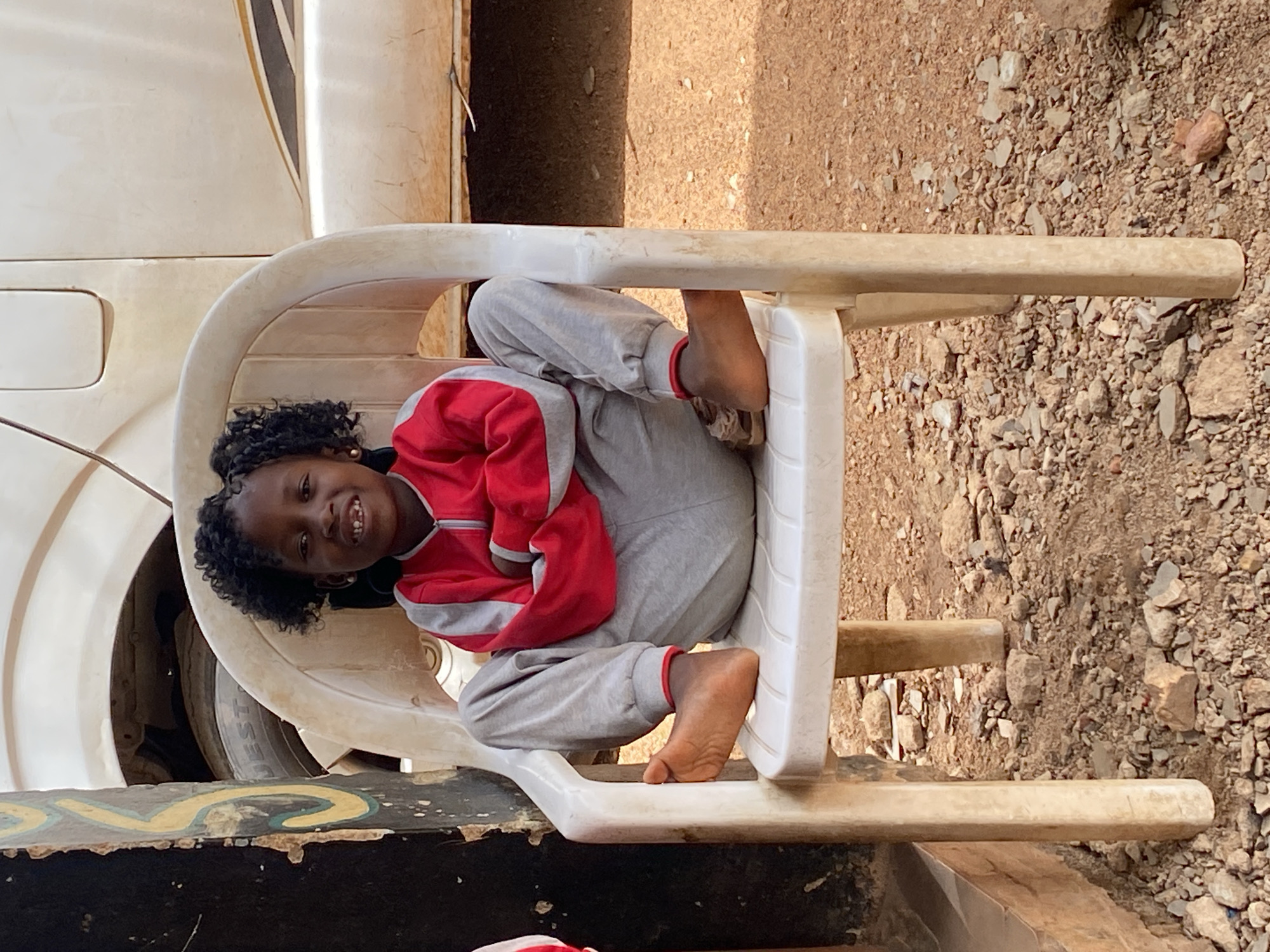 Children rest in plastic chairs in Kuru, Nigeria