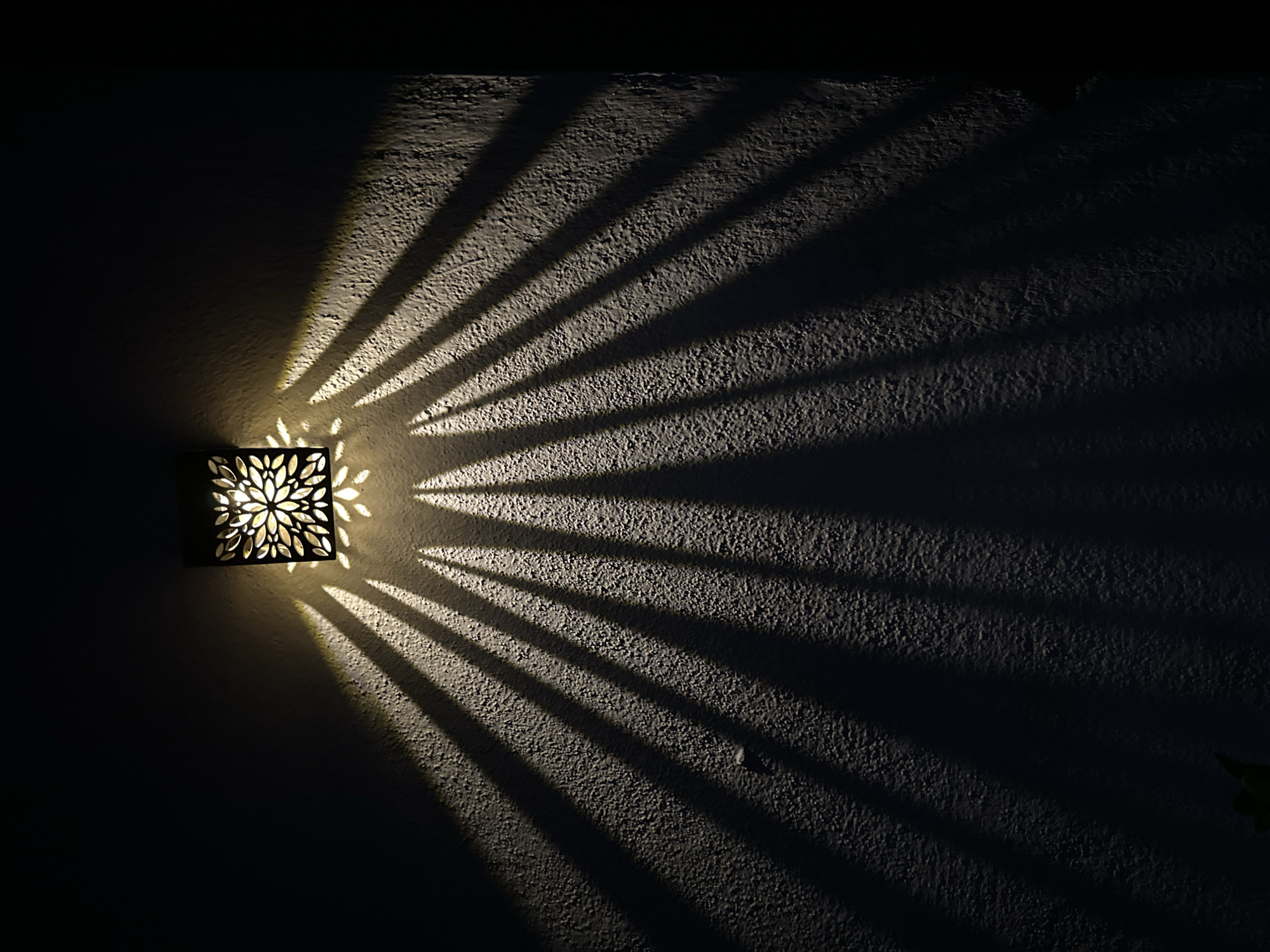 Ornate lantern casts starburst shadows at Villa Pasquali