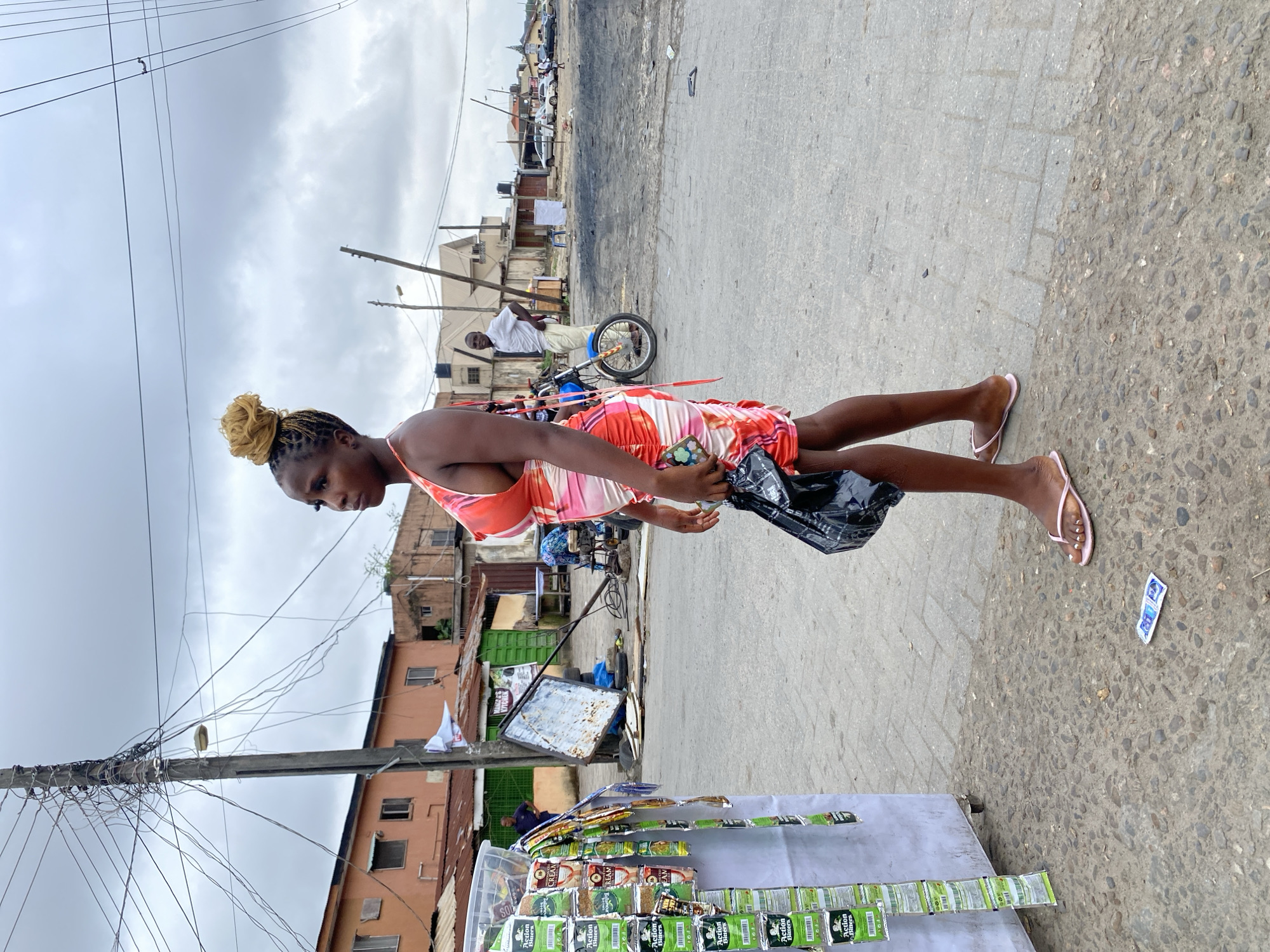 Morning street activity at an outdoor urban market or food strip.