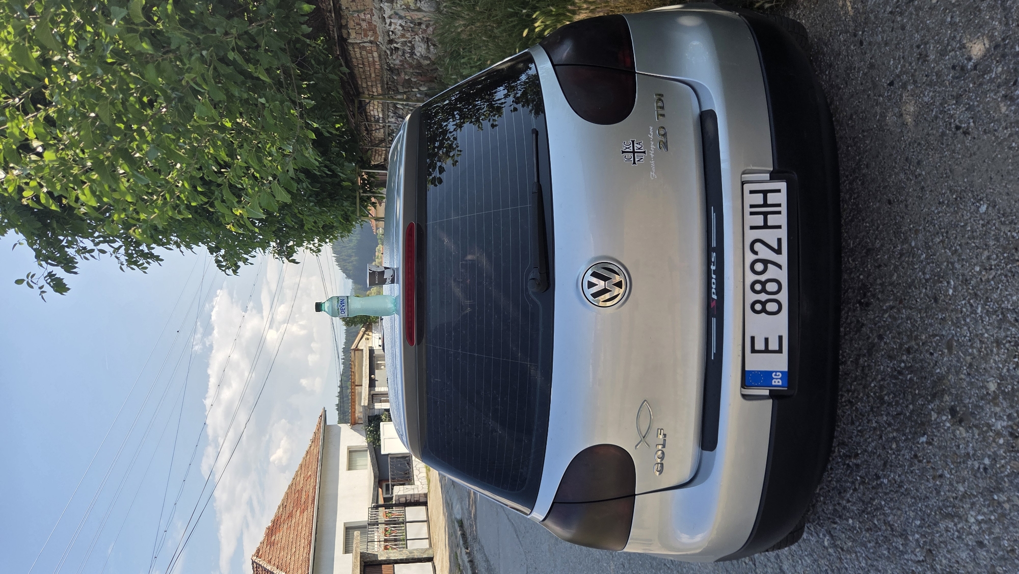 Silver VW Golf parked on a Bulgarian town street, morning
