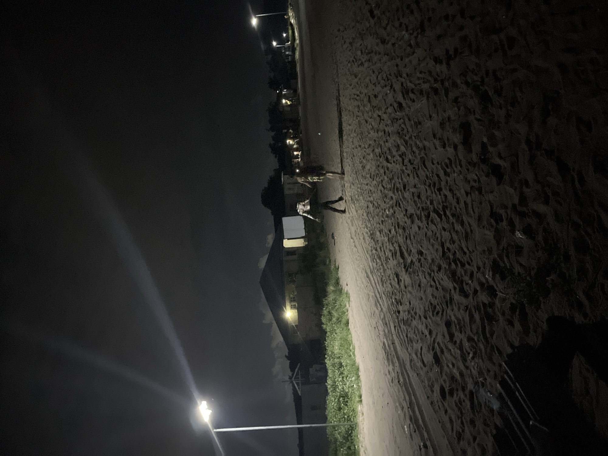 Two people spotted on urban beach during cloudy evening