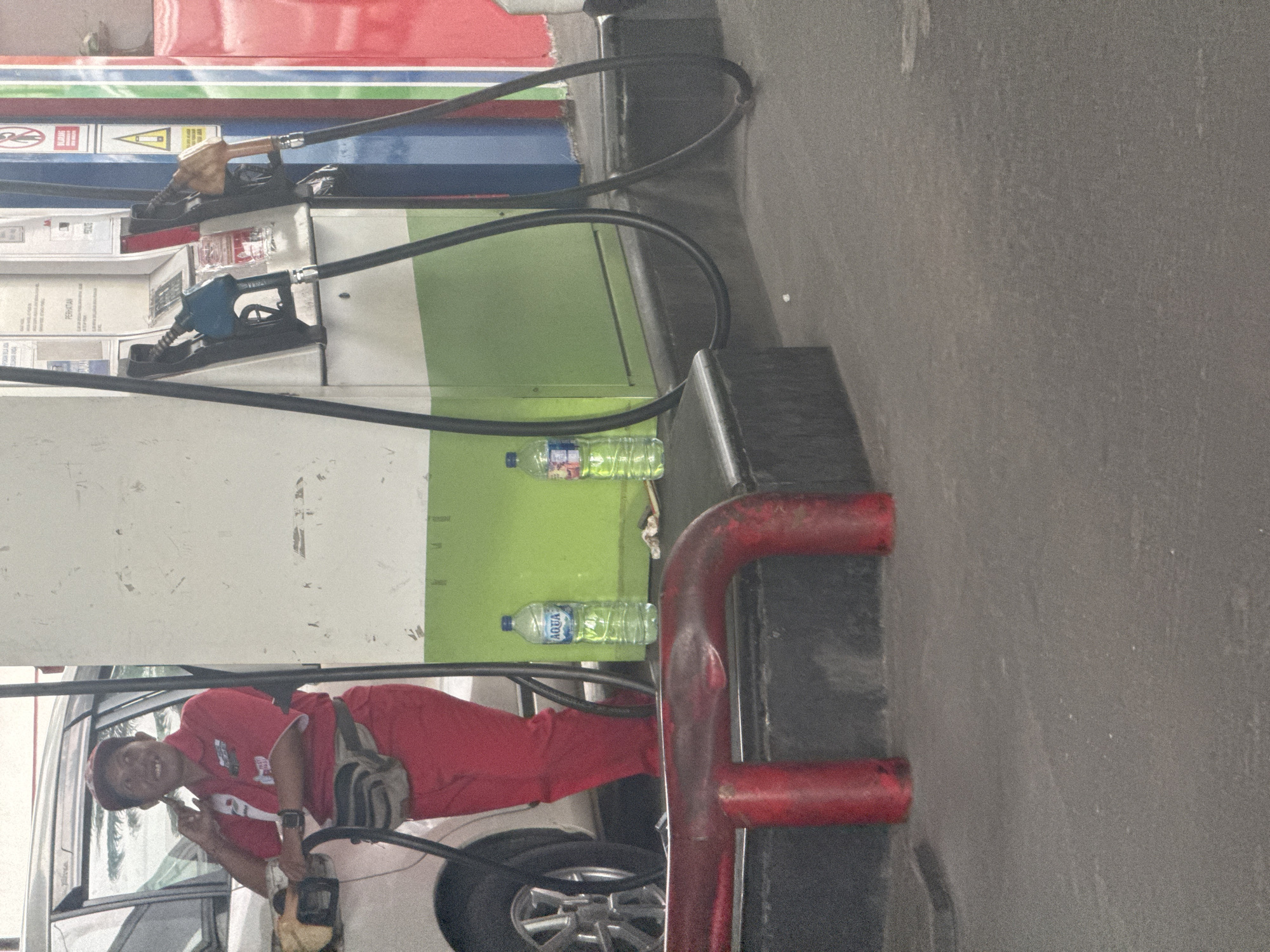 Uniformed worker at petrol station in Nusa Dua, Indonesia