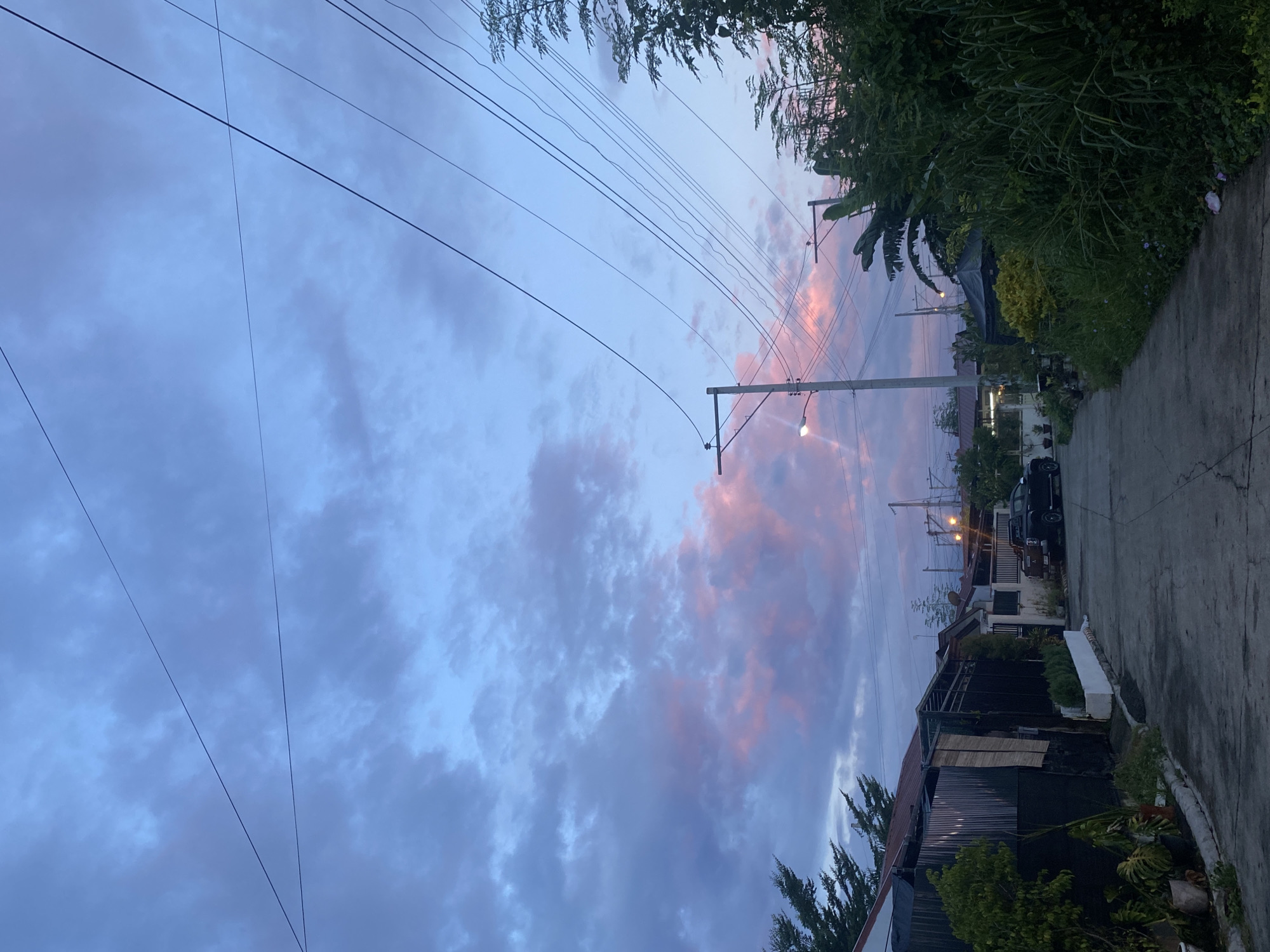 Davao City neighborhood at dusk, power lines and fading sky