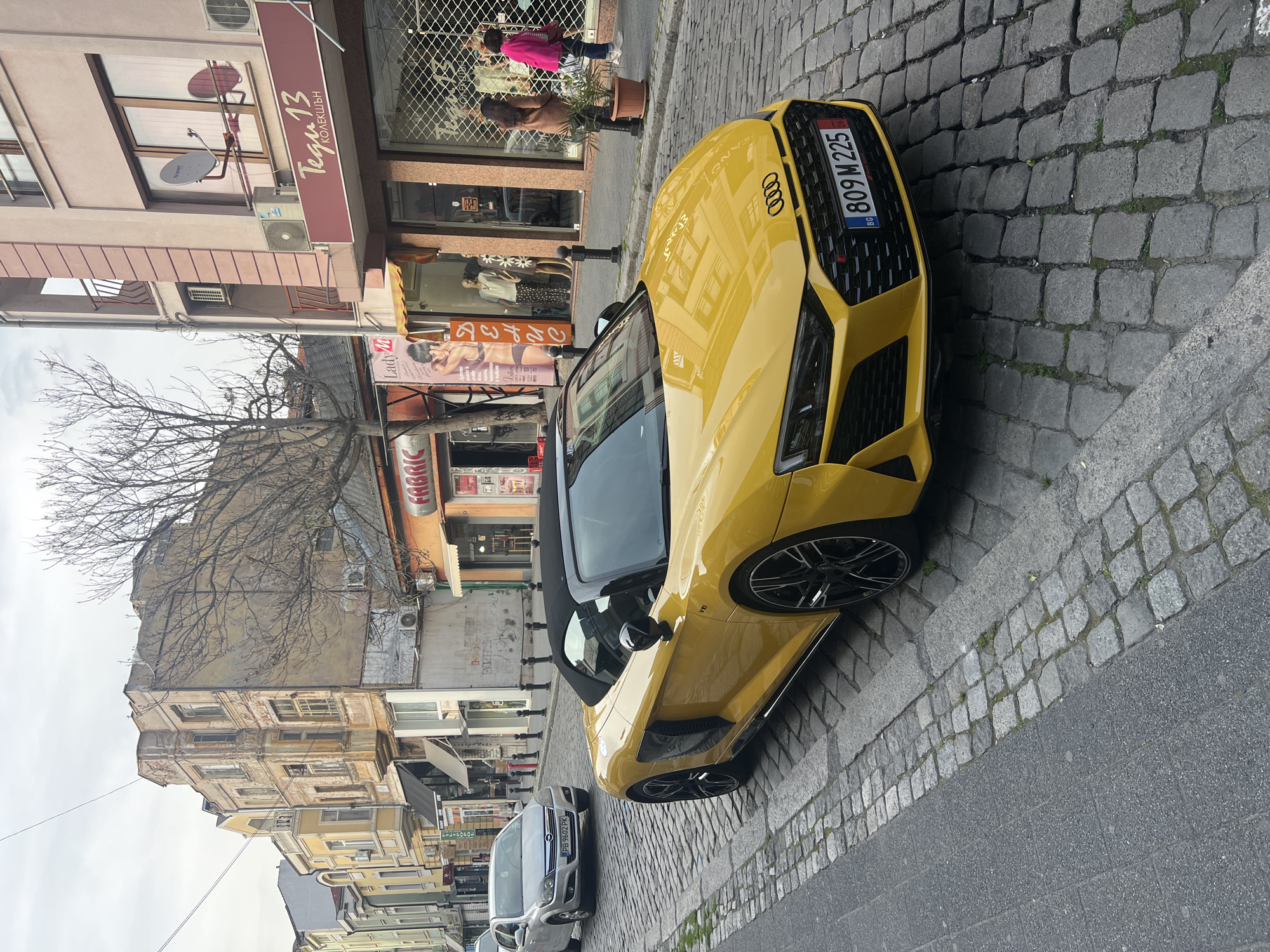 Yellow convertible, white dove spotted in urban area